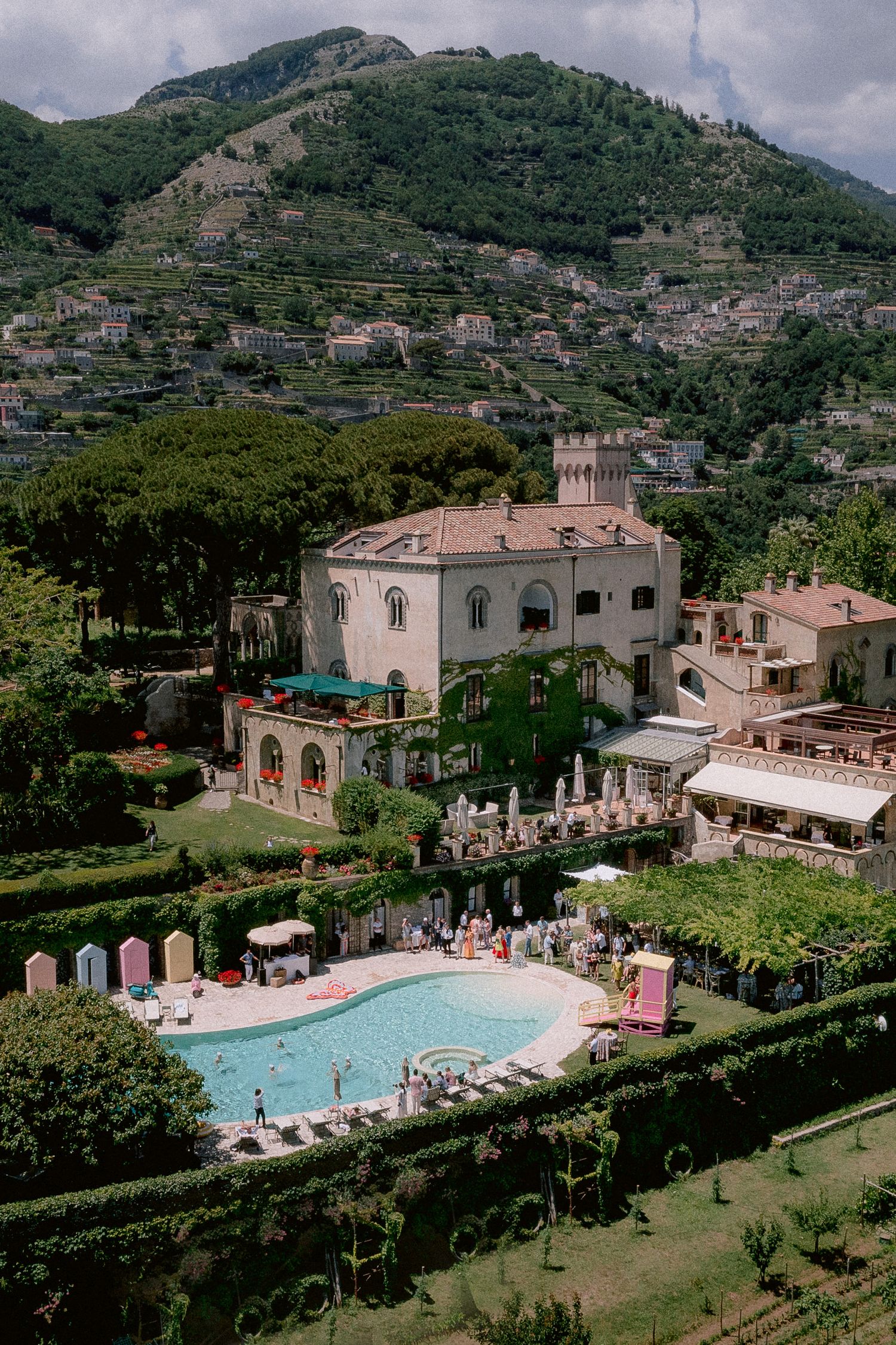 Luxury Villa Cimbrone hotel with swimming pool surrounded by terraced hills and gardens on Italy's Amalfi Coast.