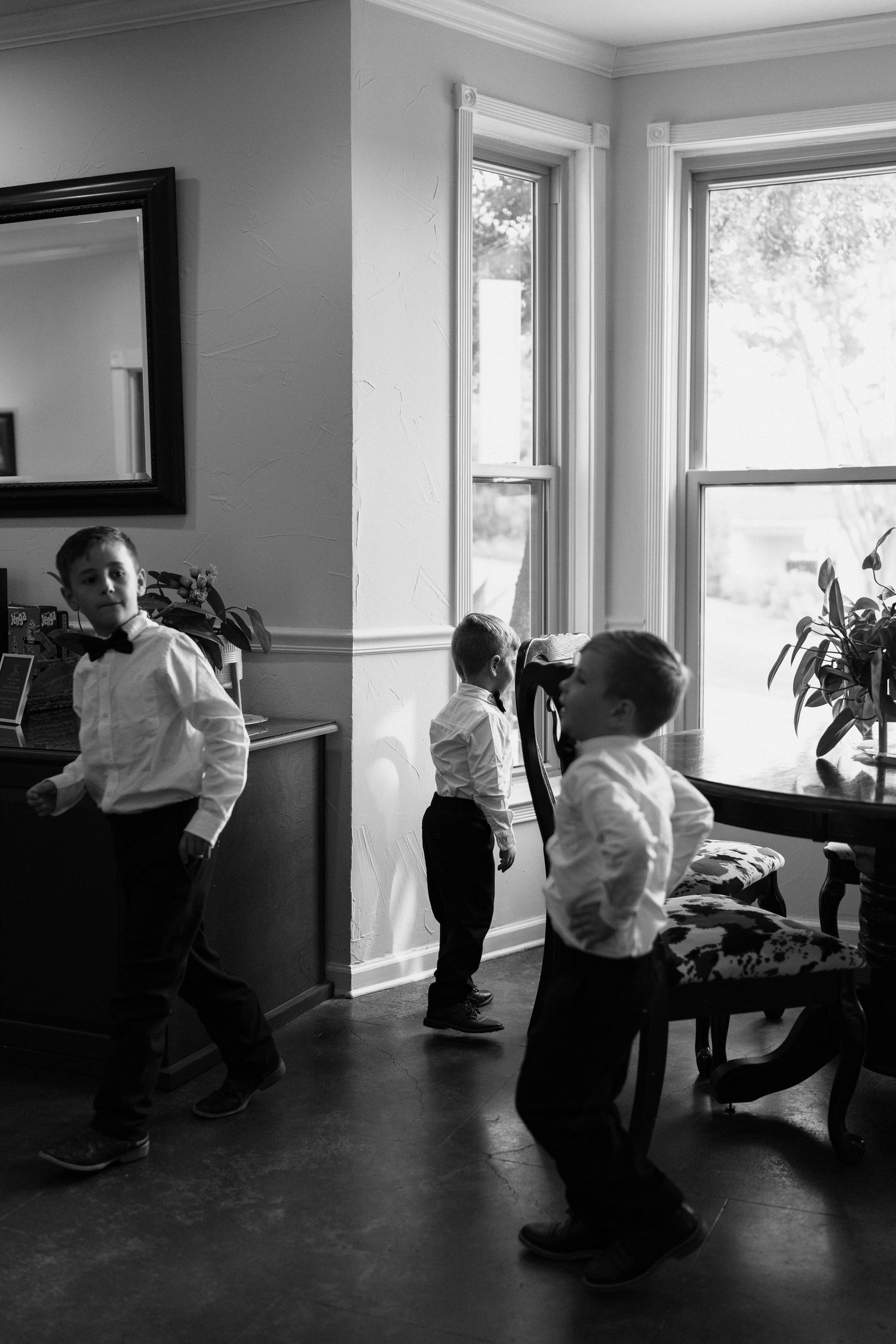A series of black and white photos showing people dancing in an intimate indoor setting with natural light from windows.