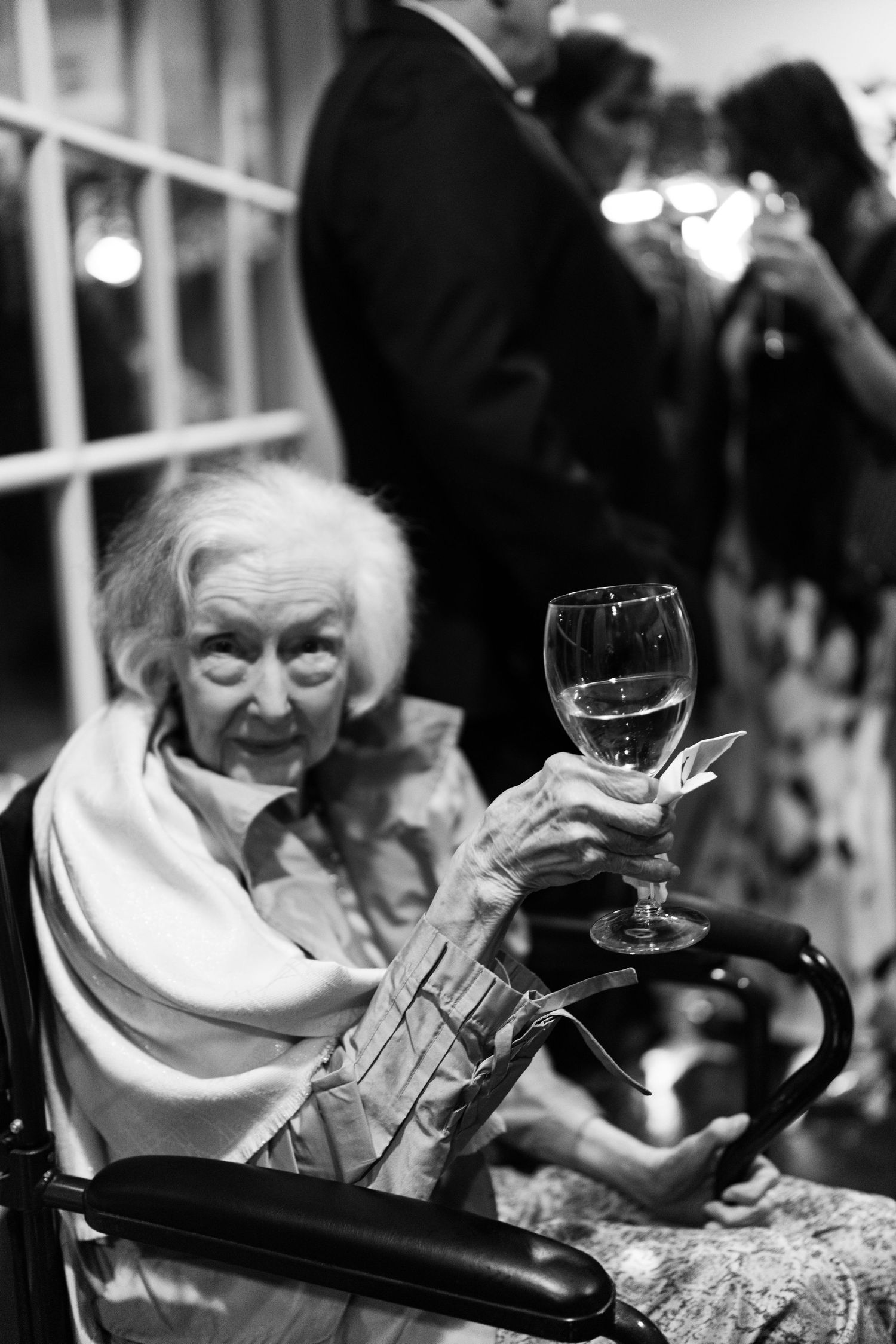 Black and white photo series showing an elderly person enjoying wine at a formal dining event.