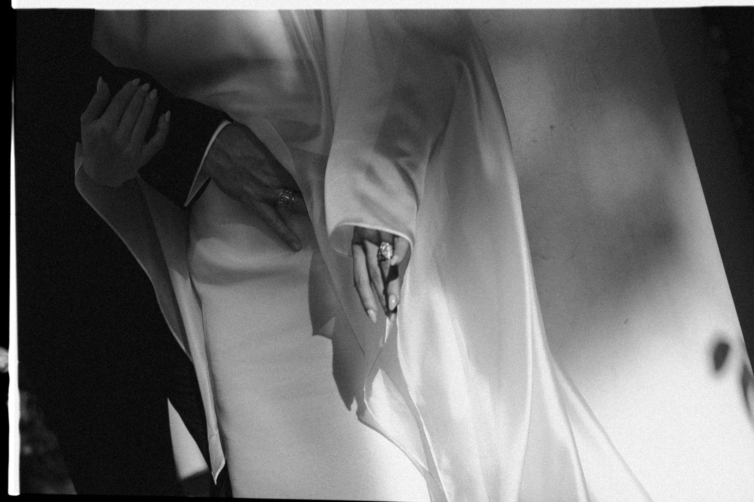 Black and white abstract photographs show ethereal movement and flowing fabric creating dramatic light and shadow patterns.