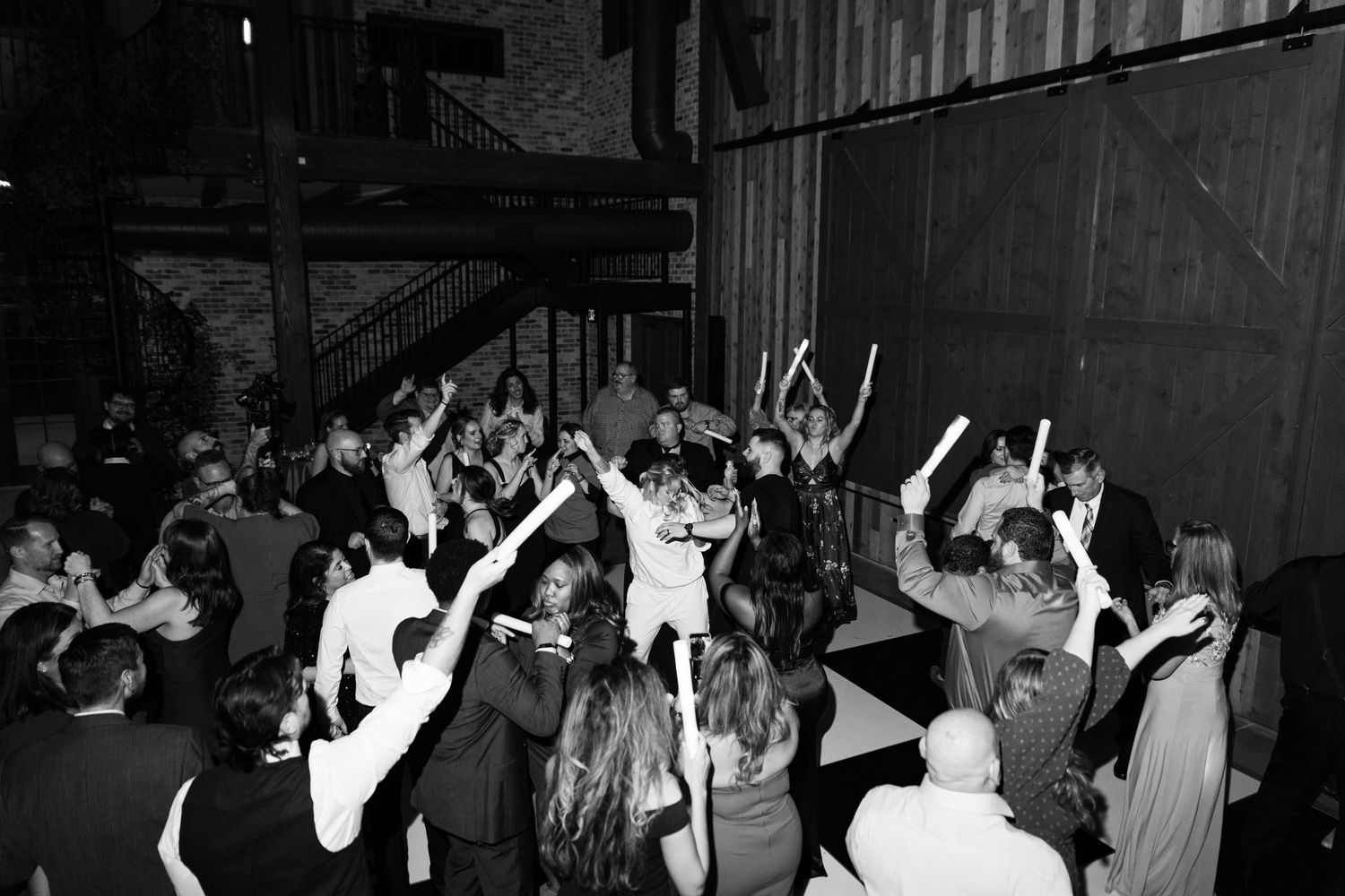 Black and white photos show a crowd dancing and celebrating at what appears to be a party or nightclub event.