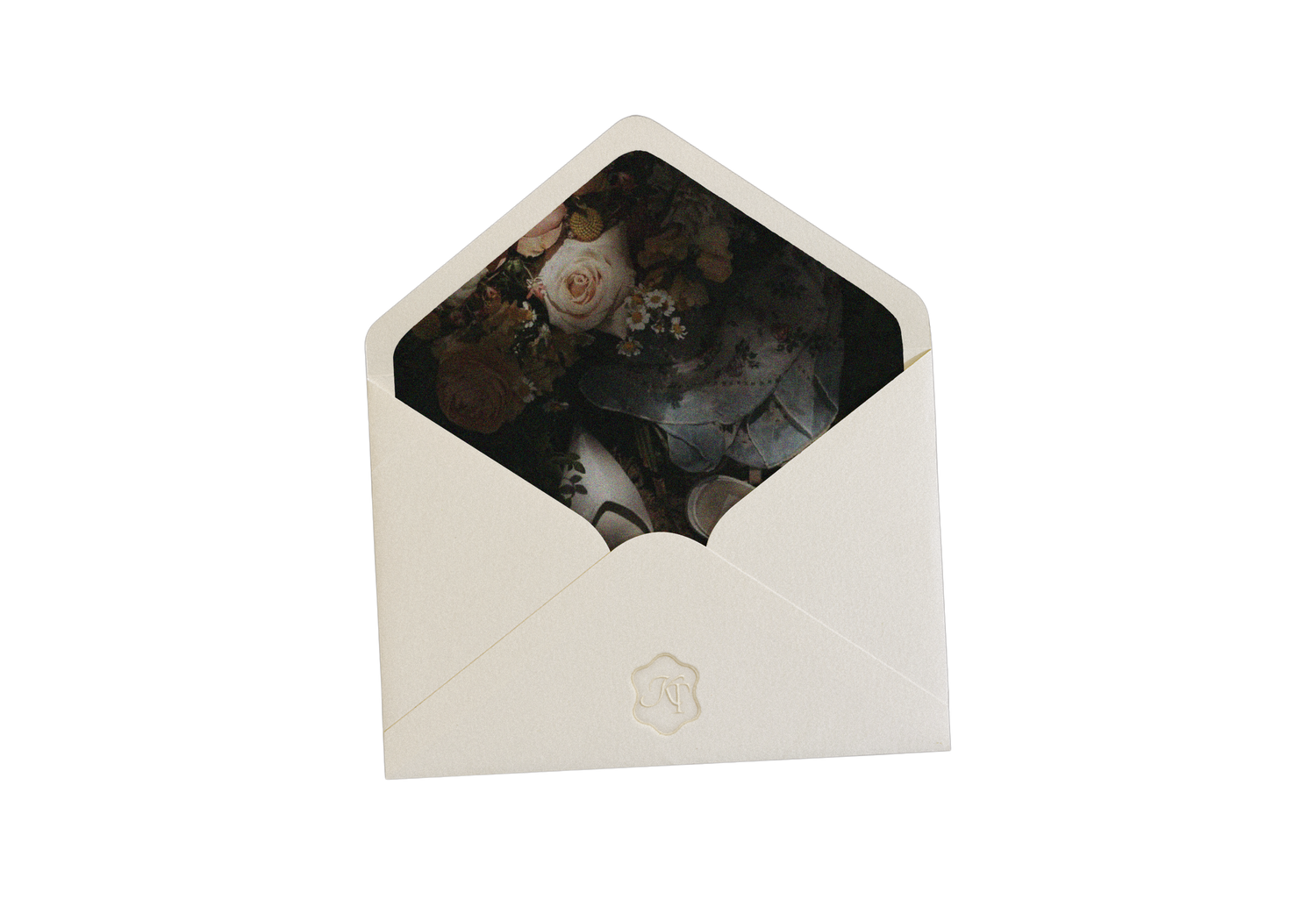 A vintage black and white photograph peeking out from inside a white envelope.
