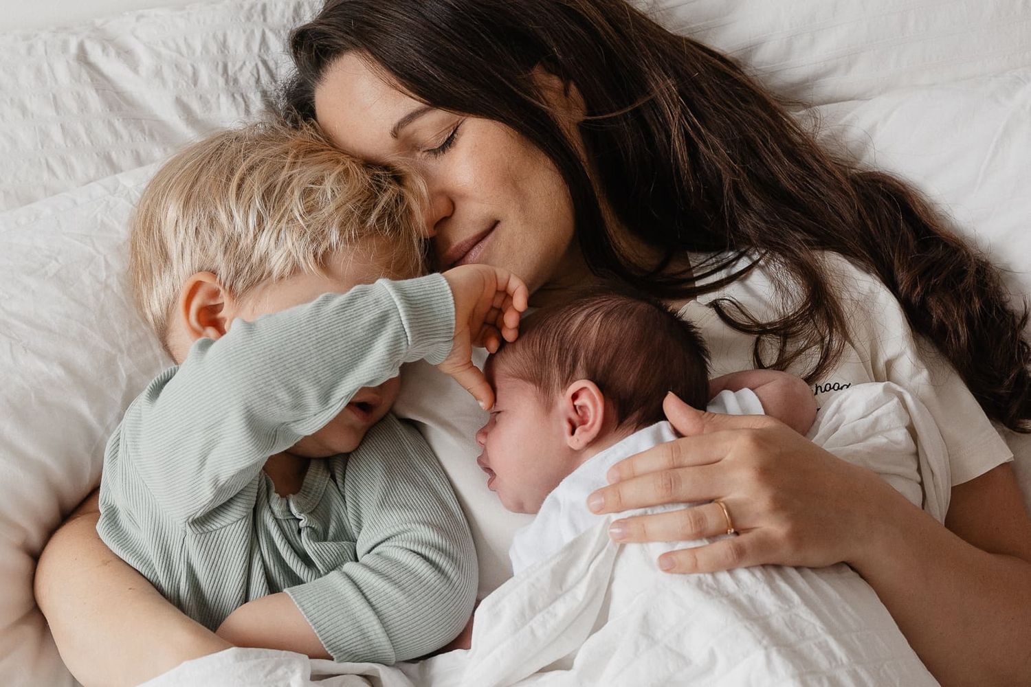 Photo d'un moment de tendresse entre une mere et ses enfants capturee par une photographe de famille lifestyle a domicile pres de Lille