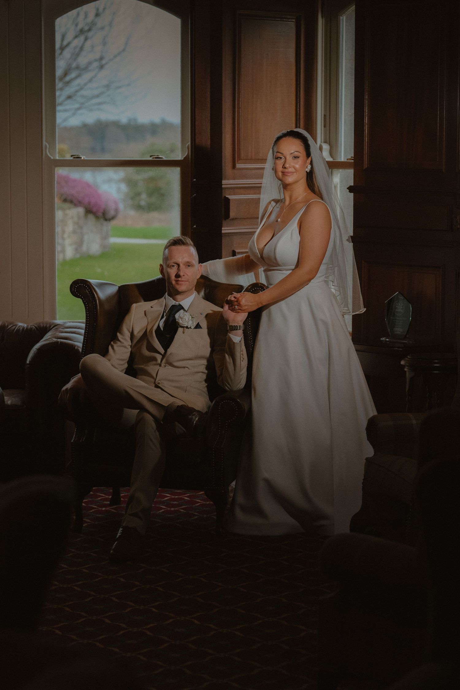 Bride and groom near window at Kilronan Castle Estate, Co.Roscommon