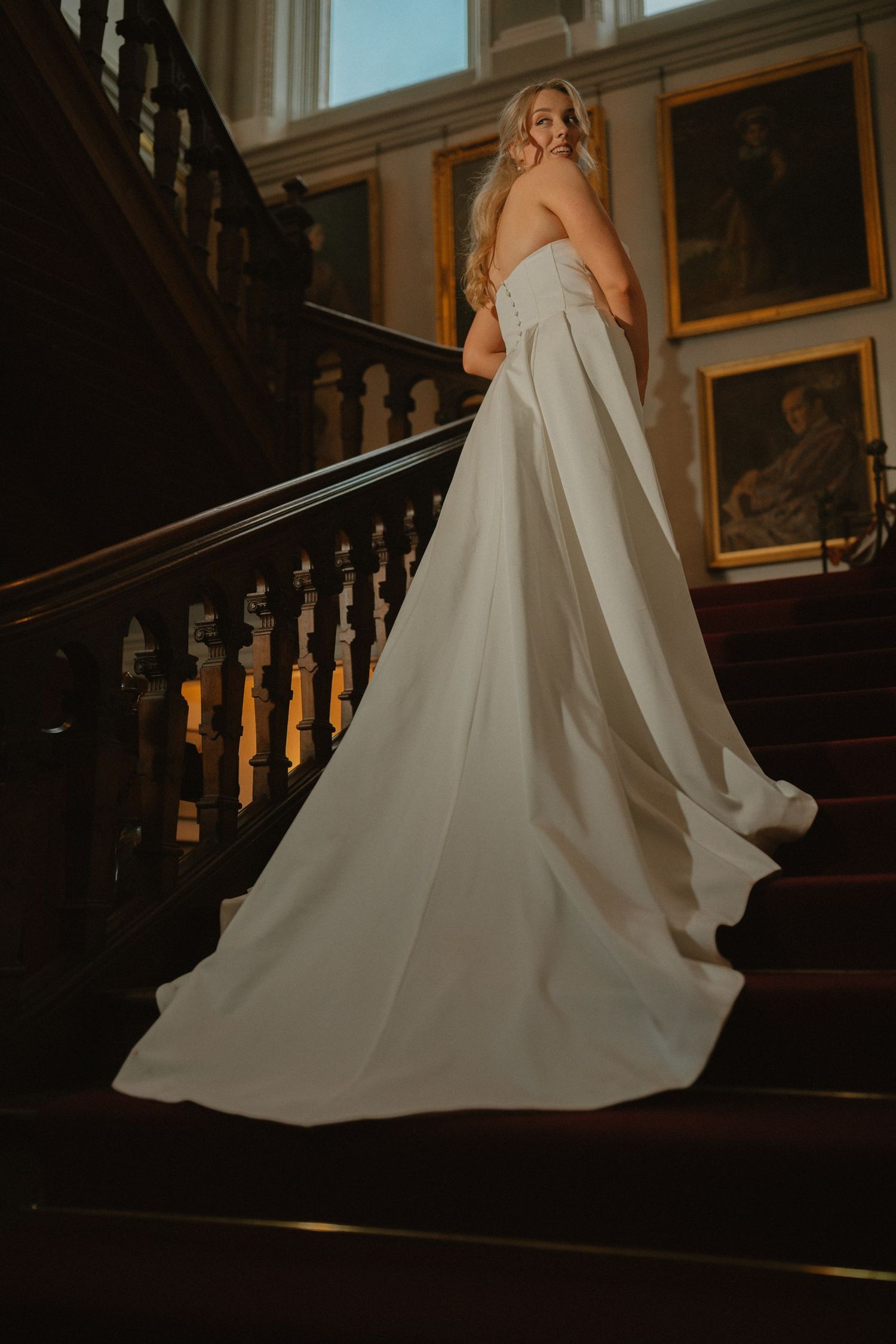 Bride on the staircase at Castle Leslie Estate.