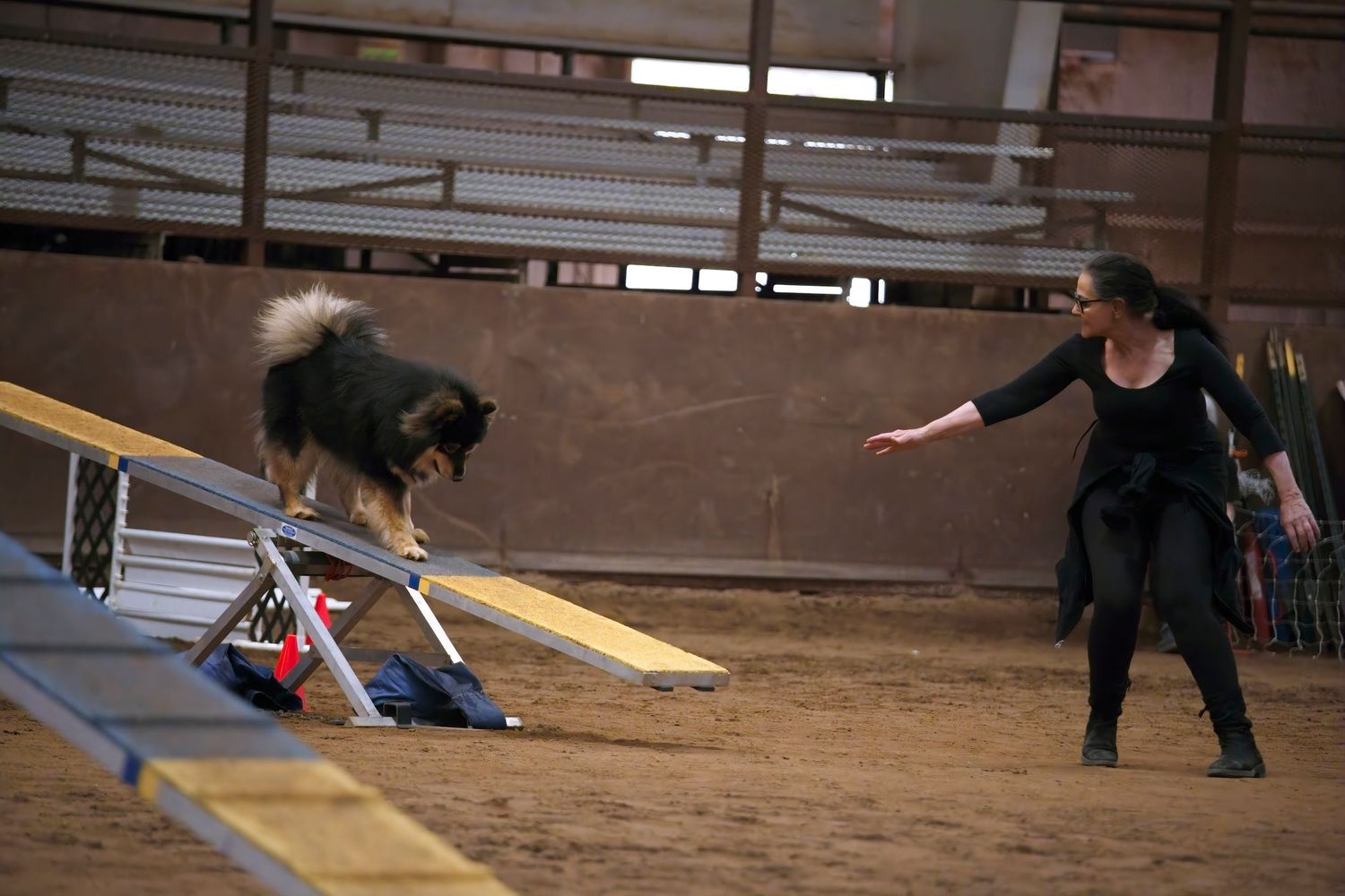 Skateboarder performs a sequence of tricks on a wooden ramp inside an indoor skate park.