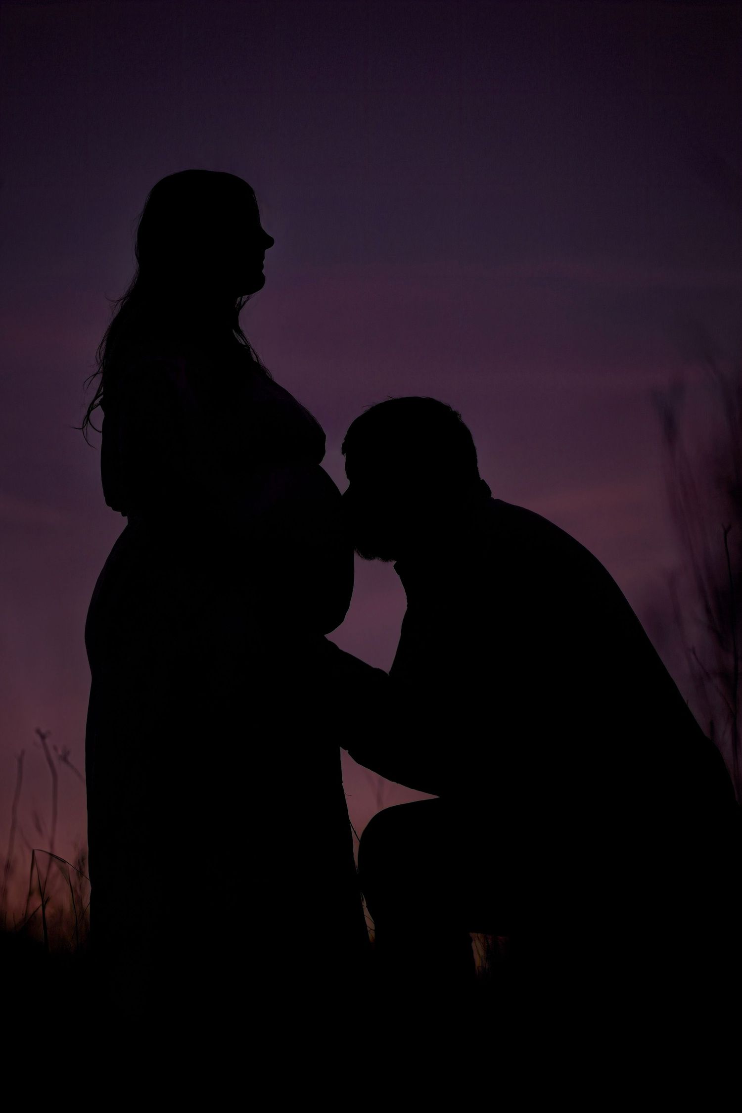 Dark silhouettes of romantic couple at sunset in multiple romantic angles and poses against purple sky.