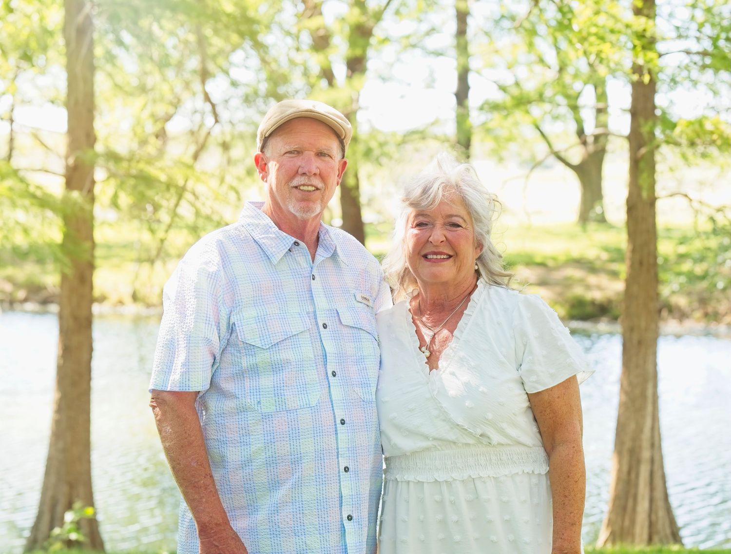 A happy couple shares a cheerful moment together by a lakeside.
