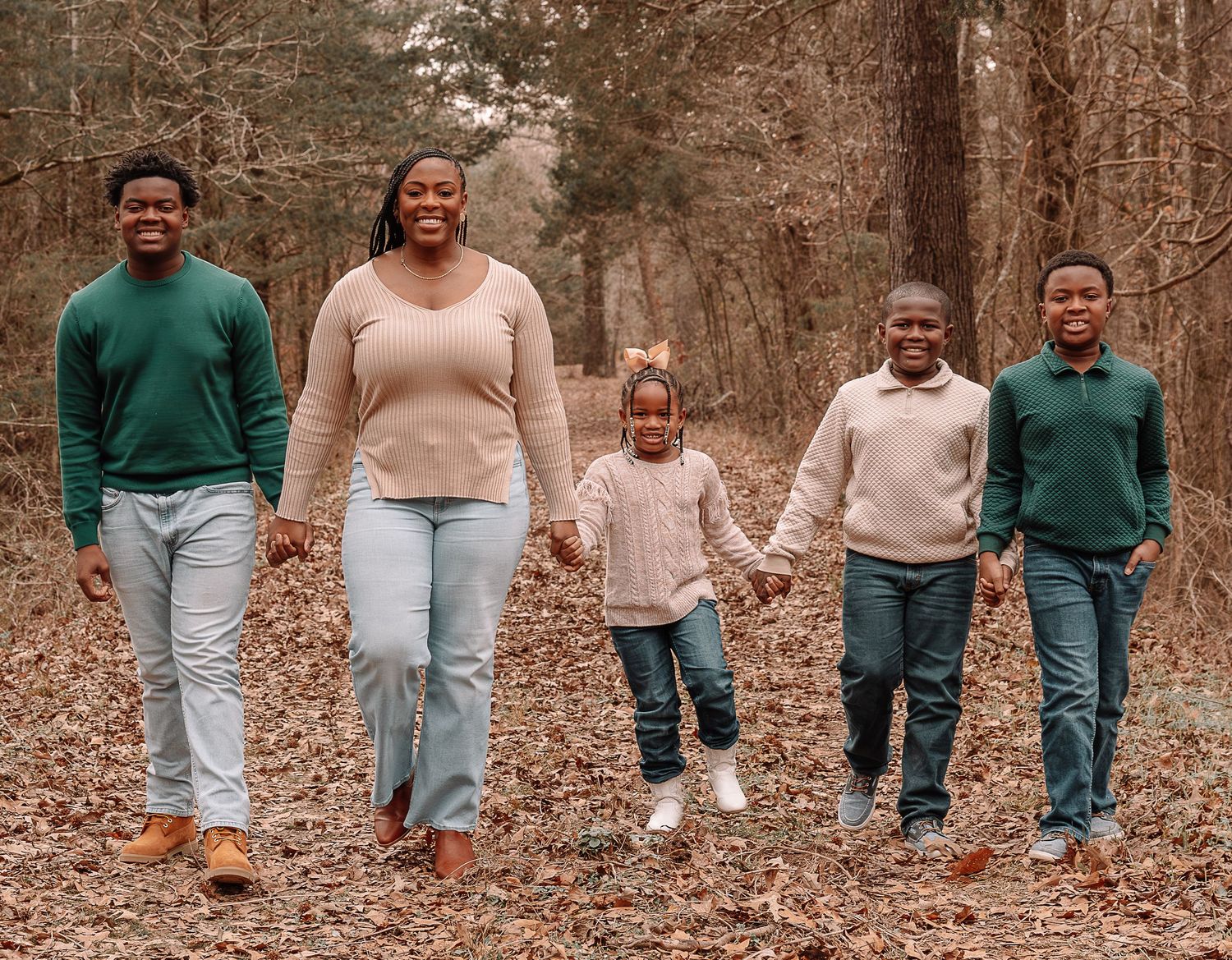 Cropped view of family members' walking through autumn leaves.