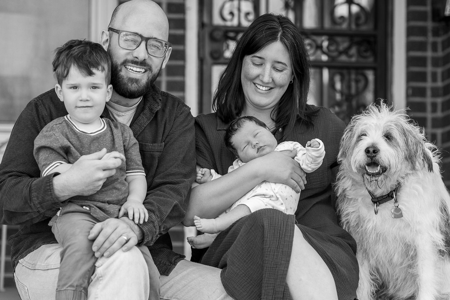 A collage of black and white family photos showing tender moments with children and a white dog.
