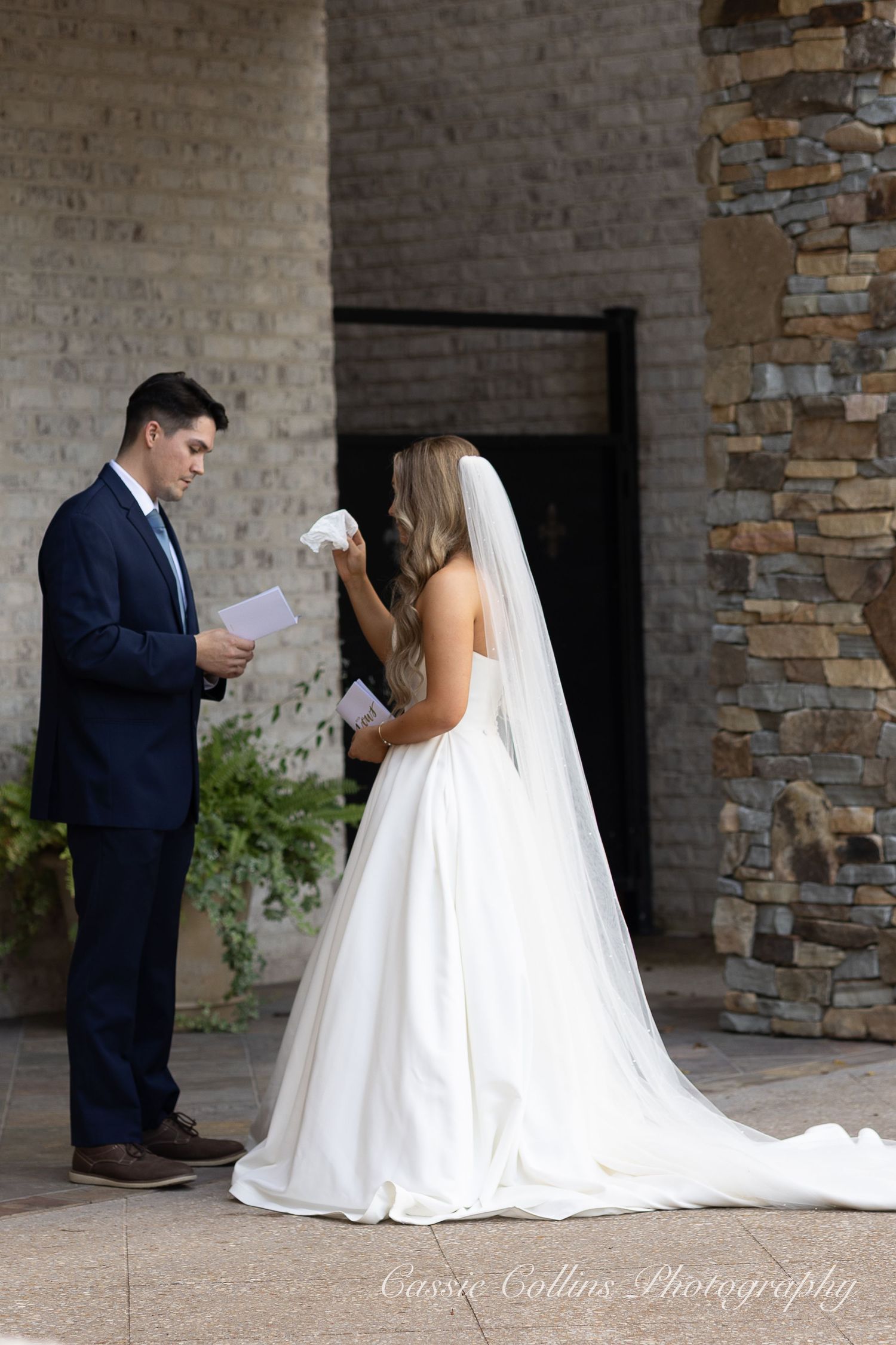 A bride and groom share a private moment reading letters to each other before their wedding ceremony.