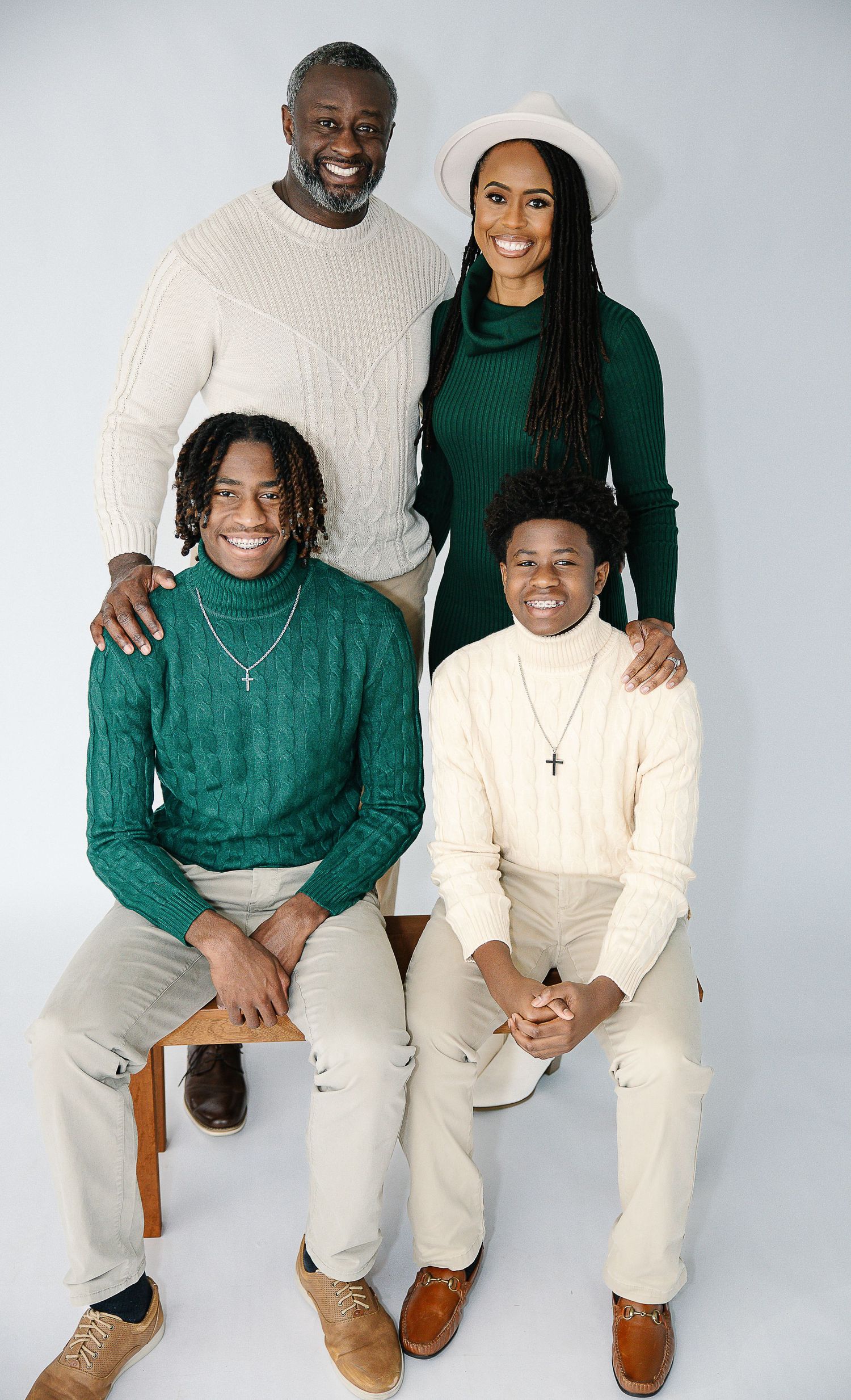 Group portrait series showing people in matching green and cream colored sweaters sitting casually together.