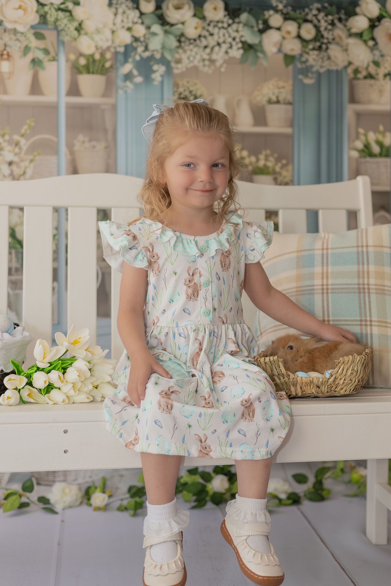 A floral dress and white boots outfit shown in multiple angles with spring decor and white furniture.