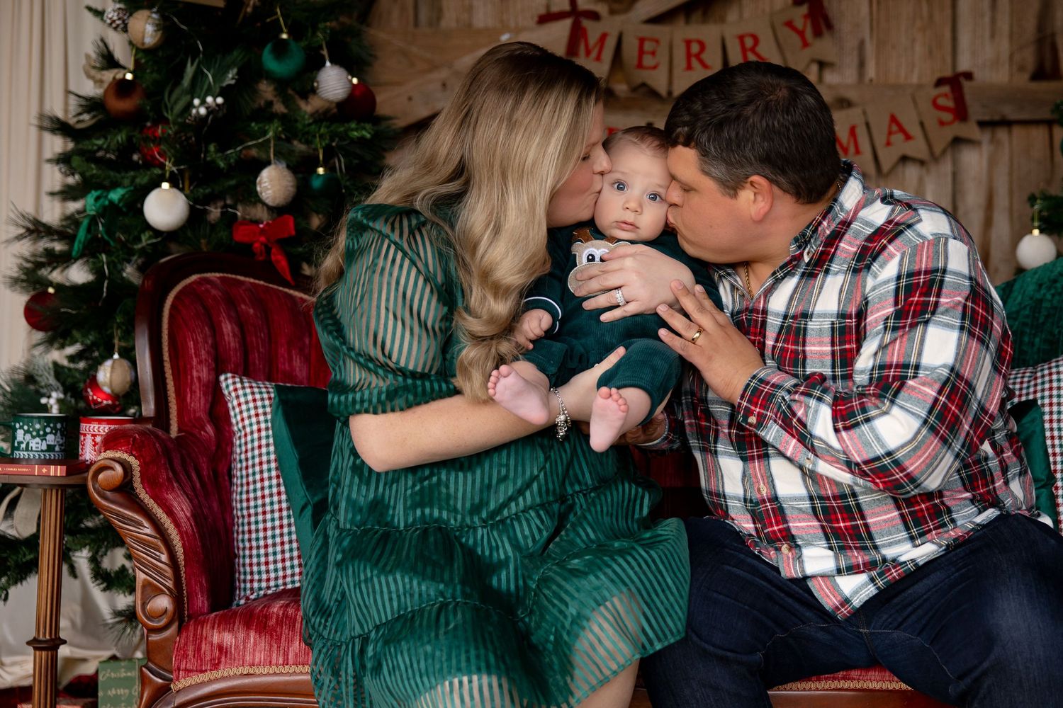 A family shares a tender holiday moment by a decorated Christmas tree in a cozy living room setting.