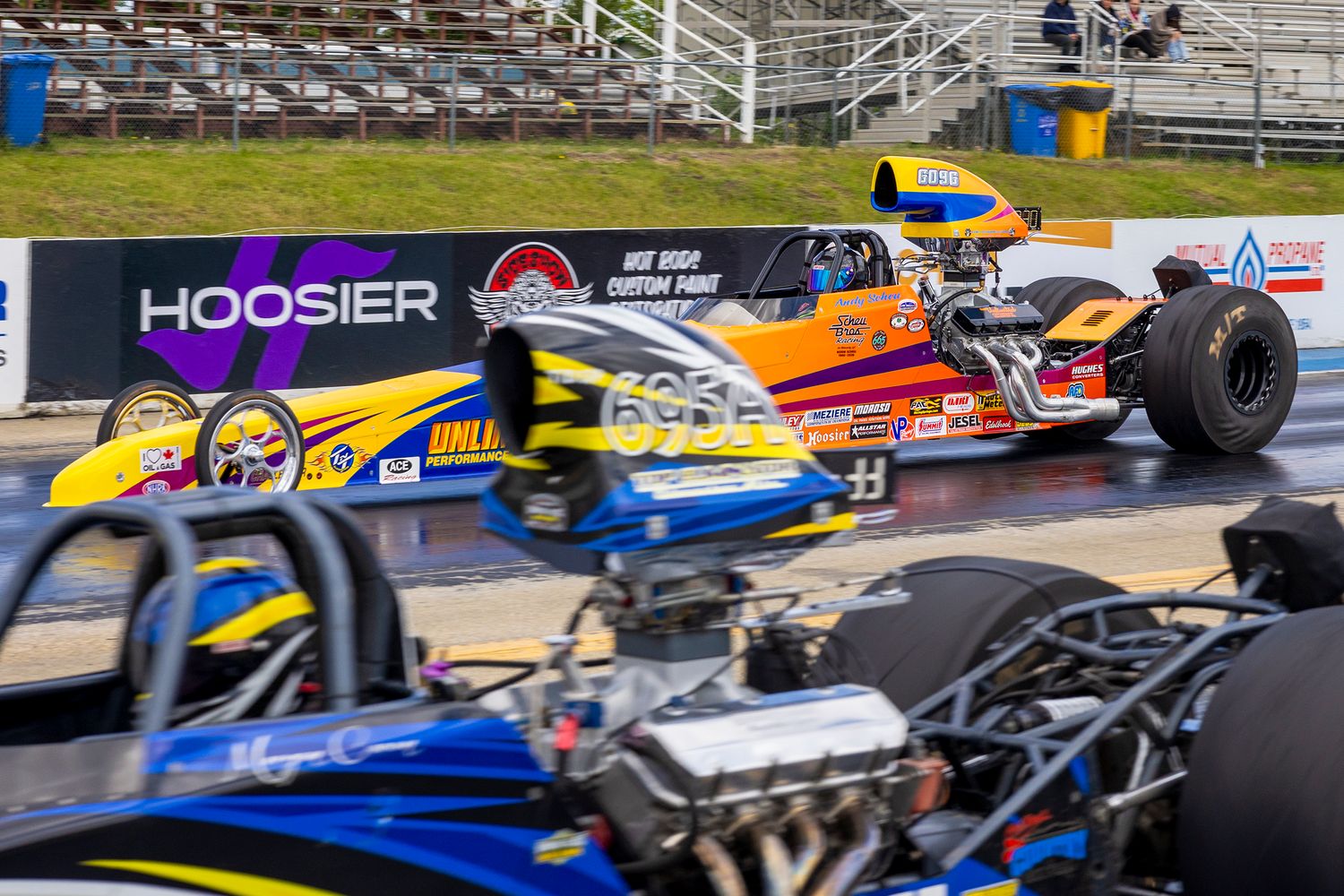 Top Eliminator dragsters launch side by side down the strip at Rad Torque Raceway in a high-stakes heads-up battle.