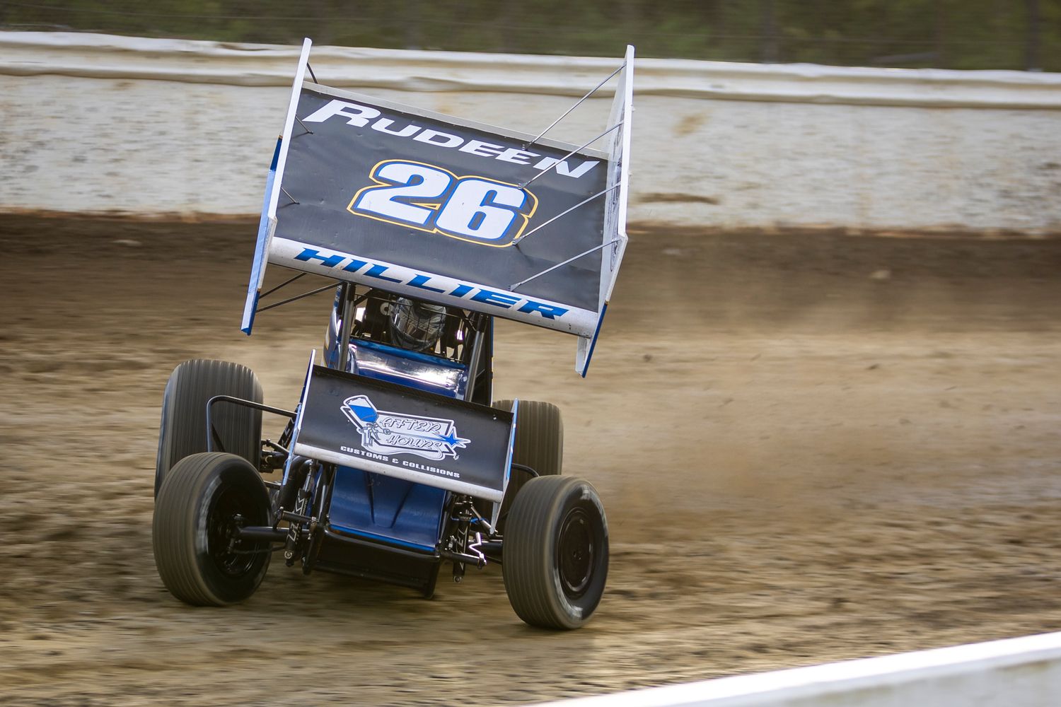 Blue No. 26 sprint car kicks up dirt mid-slide during a high-speed turn at Skagit Speedway on May 10, 2025.