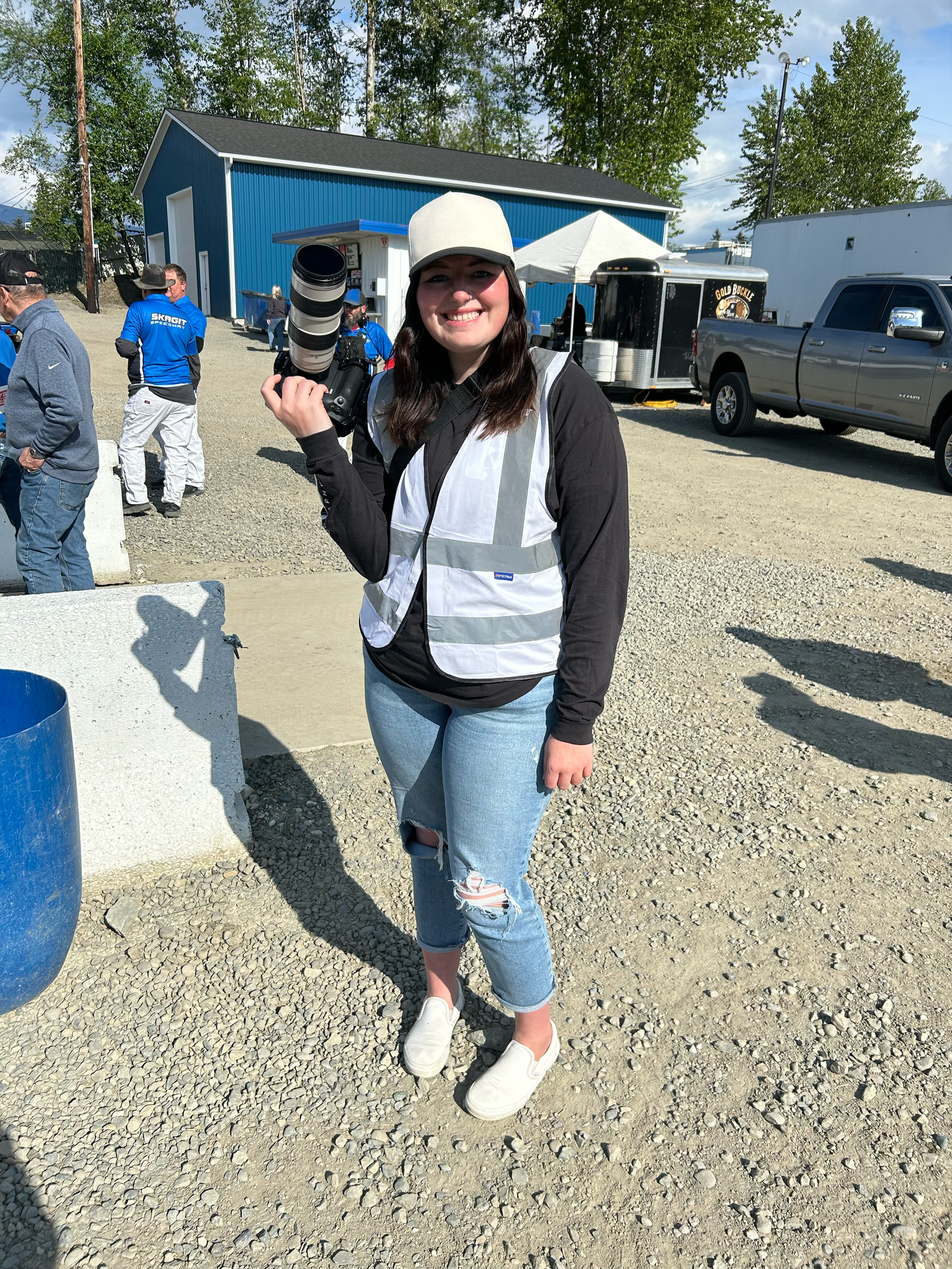 Becky from Fuelled Up Photography smiles trackside in casual gear during a motorsports event.