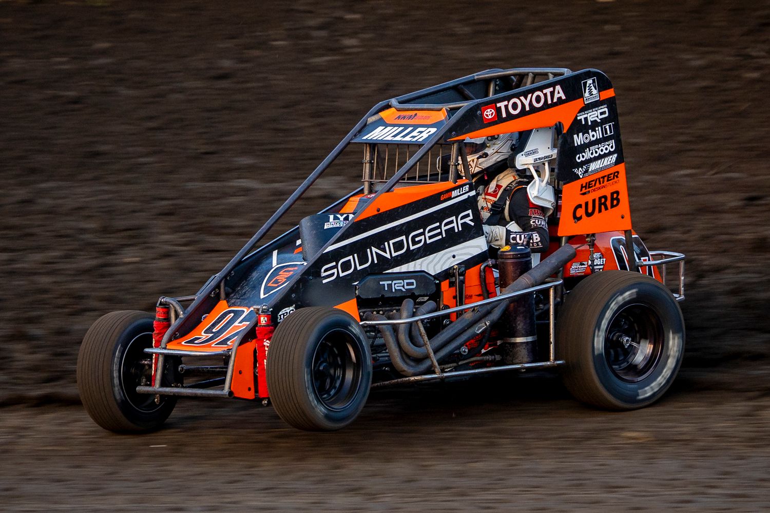 Midget dirt car racing at Farmer City Raceway, SoundGear-sponsored midget during WoO Late Models event in April 2025.