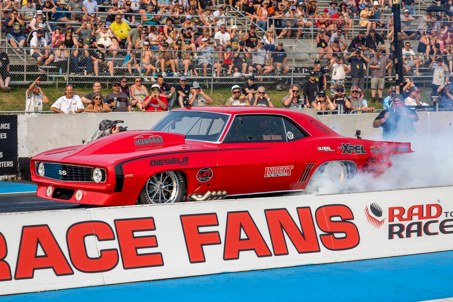 Ryan Martin in the Fireball Camaro with a smoky burnout in front of packed stands at Rad Torque Raceway during No Prep event.