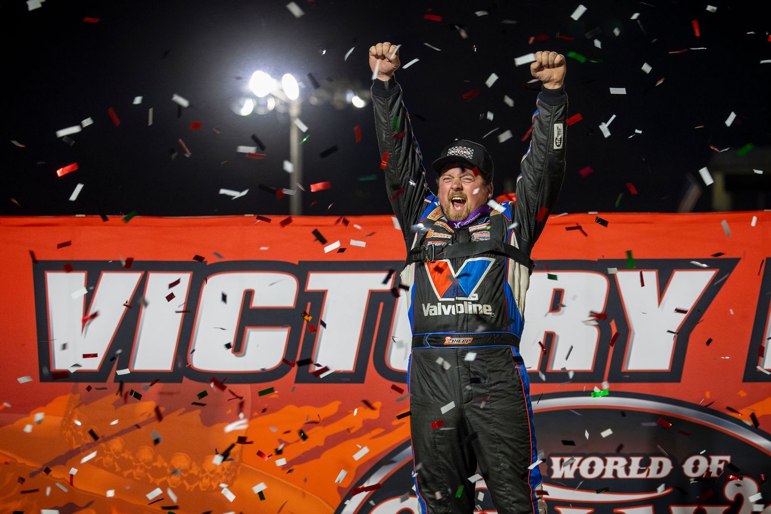 Late Model winner celebrates with arms raised and confetti flying at Farmer City Raceway on April 12, 2025.