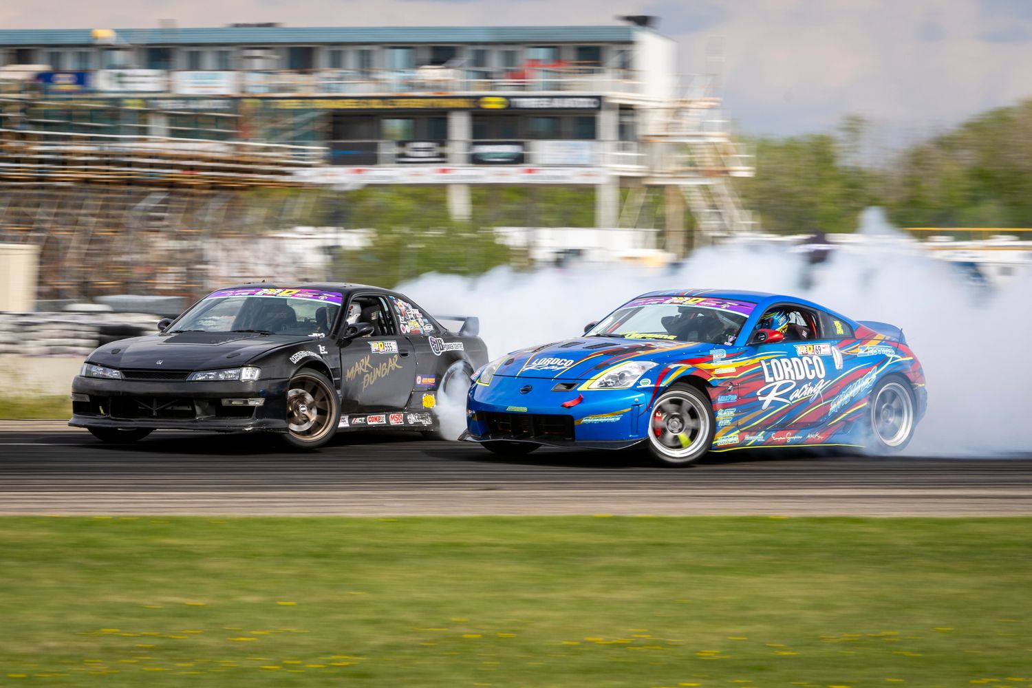 Two drift cars throw smoke and angle in a tight tandem battle during Spec D at Rad Torque Raceway, May 2025.