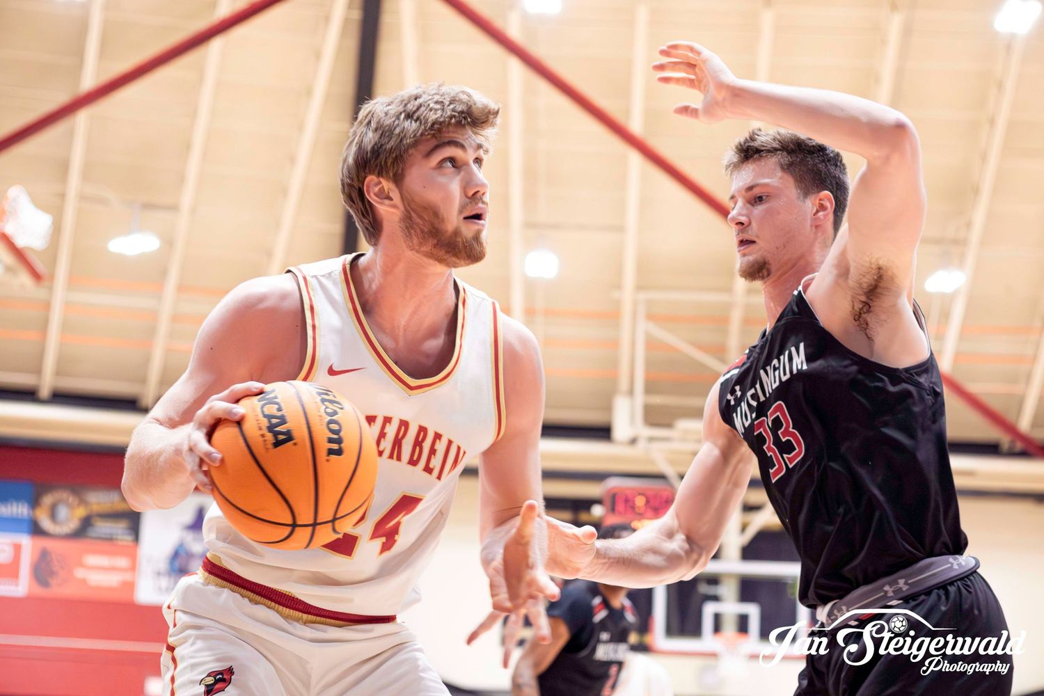 Basketball players compete intensely during an indoor recreational league game at a community gymnasium.