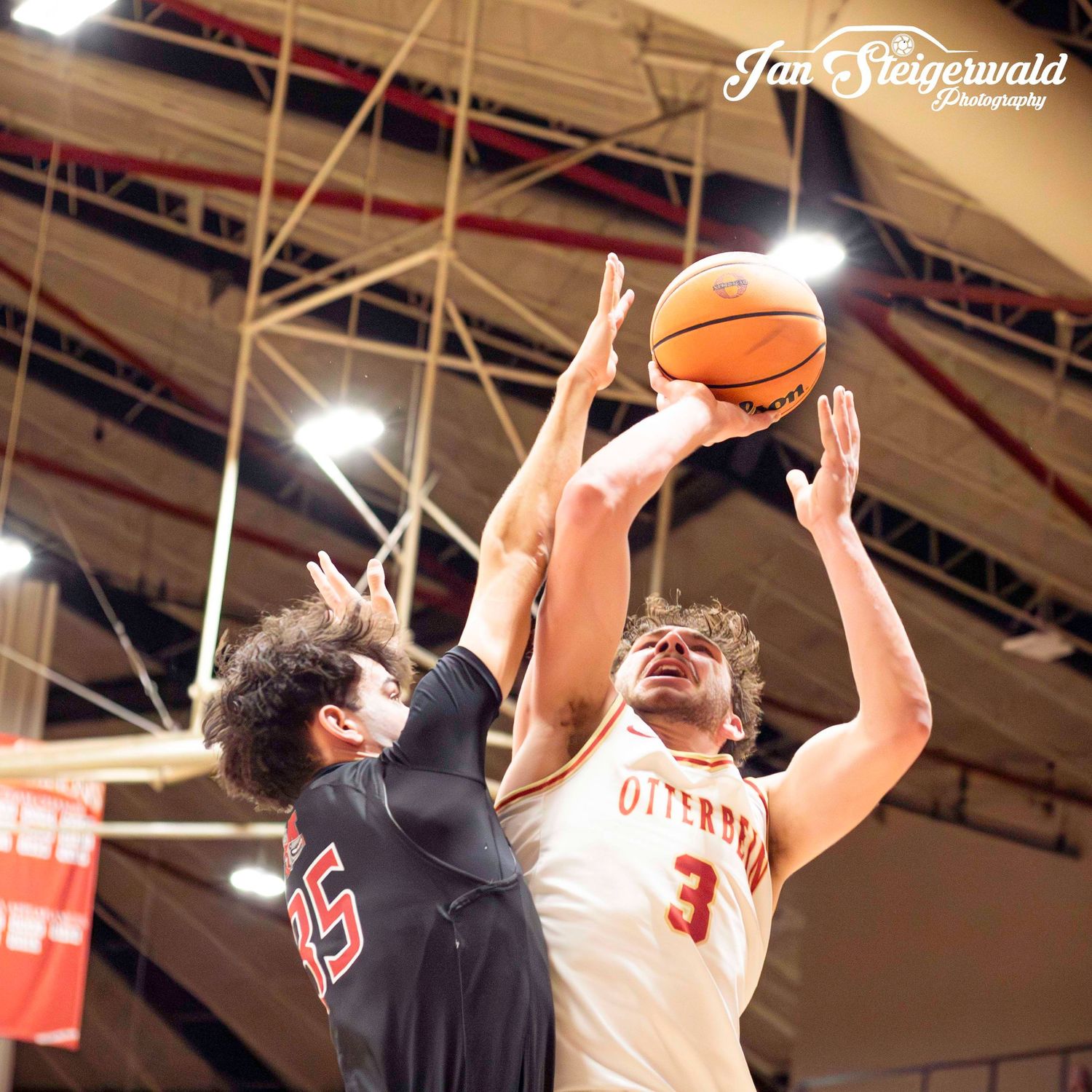 Players from Otterbein and their opponents battle for a loose ball during a basketball matchup.