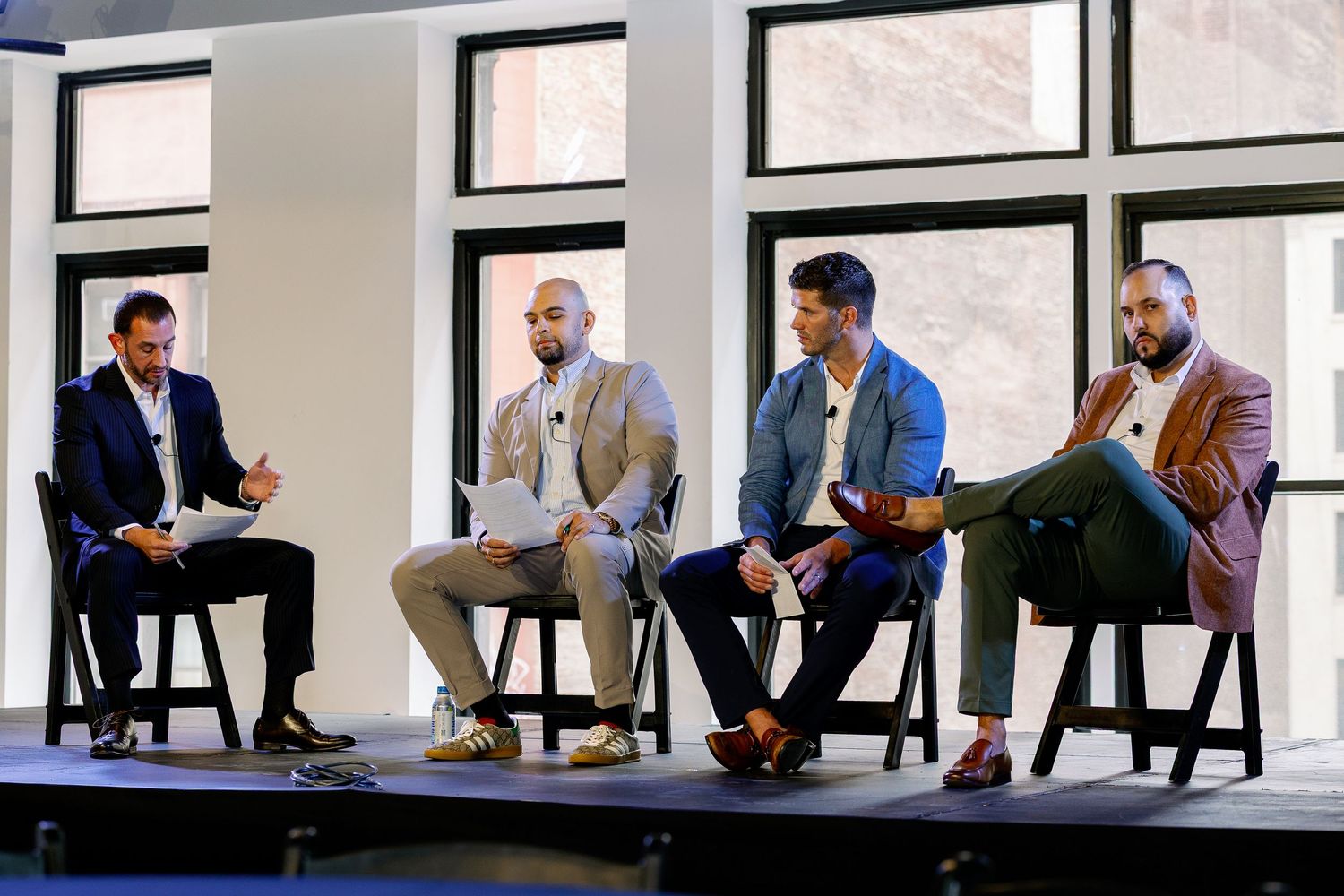 Business professionals seated at a long conference table during a corporate meeting in a modern office space.
