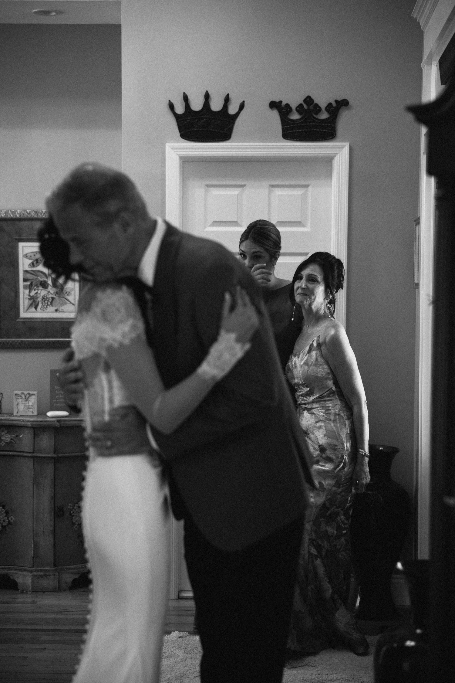 A series of black and white wedding photos showing a couple dancing and embracing during their first dance at a reception.
