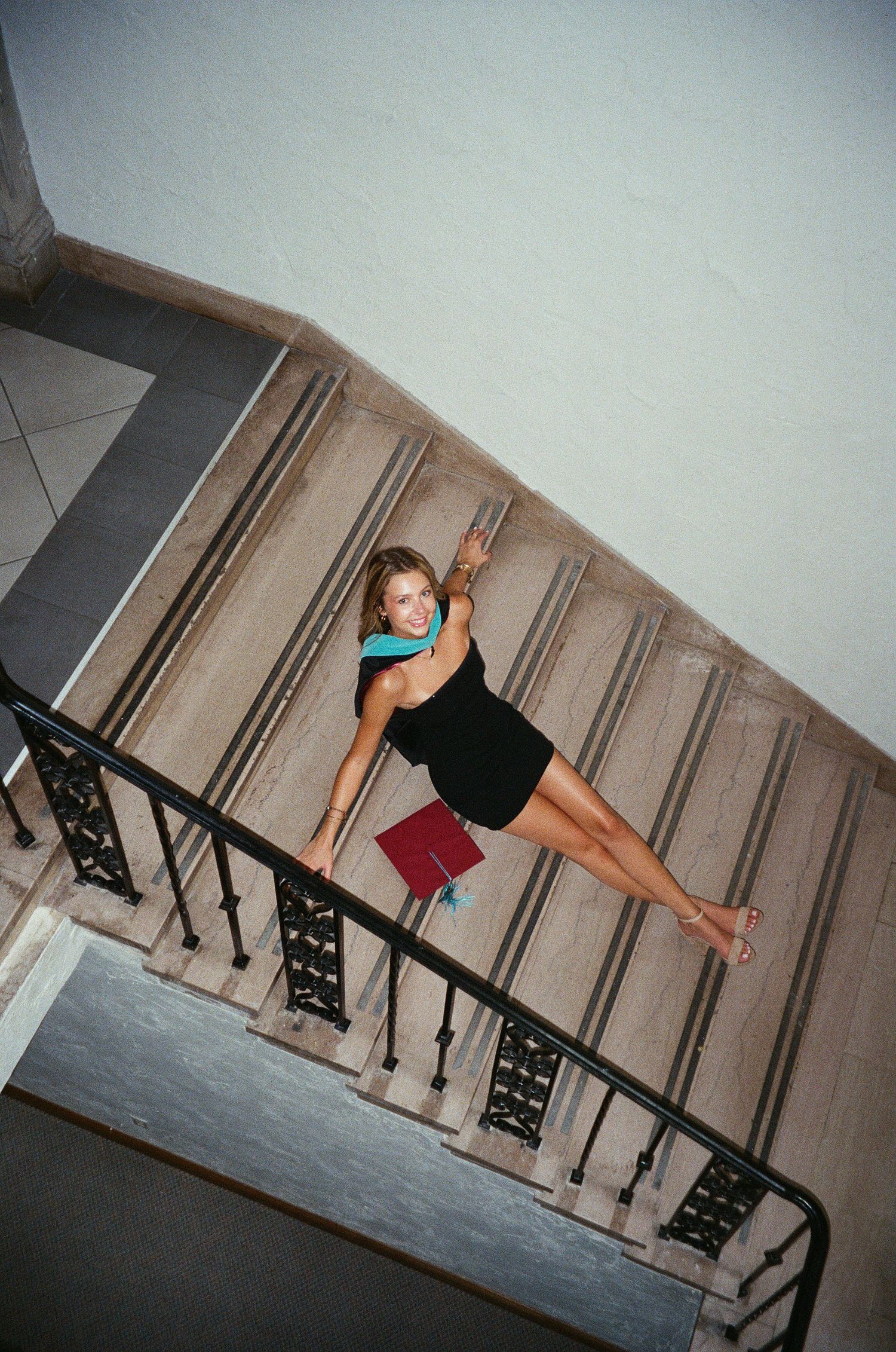A sequence of photos showing someone performing a backflip off a staircase railing in an indoor setting.