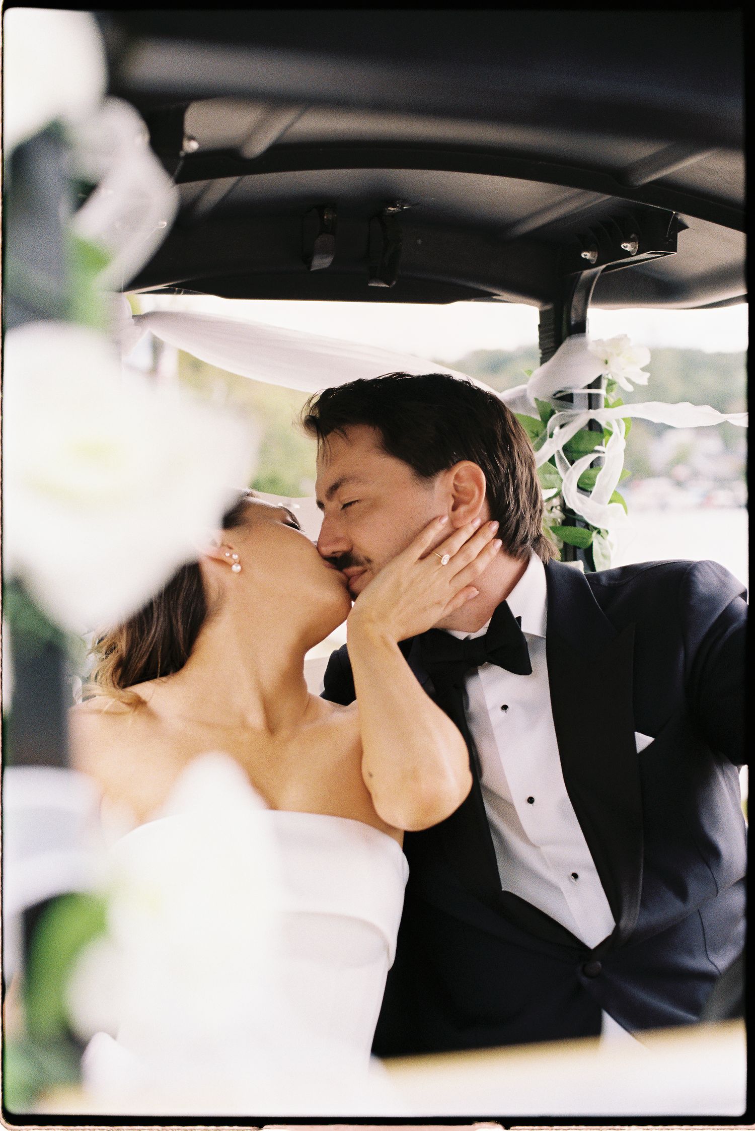 Romantic black and white photo sequence showing a couple sharing an intimate kiss inside a car after their wedding.