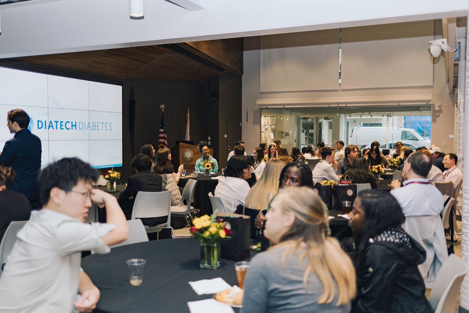 A series of training or educational sessions showing groups of people seated in conference rooms during presentations.
