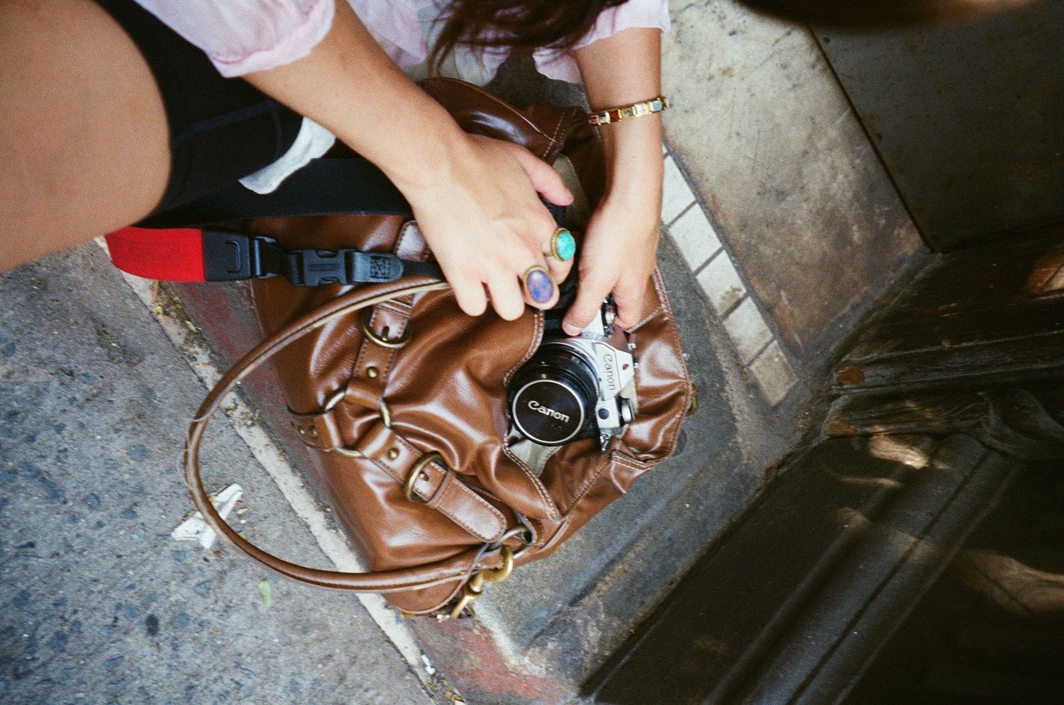Hands adjusting a vintage metal bicycle seat with leather trim during maintenance.