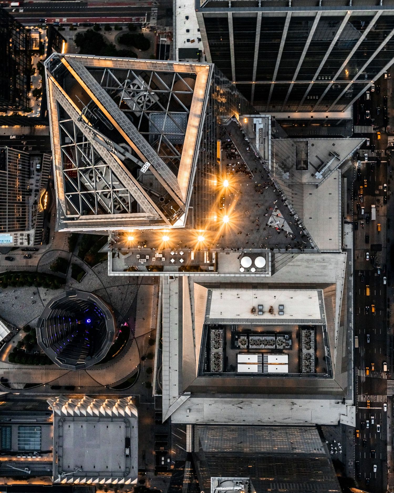 Aerial view of Edge, NYC's architecture at night showing geometric patterns and industrial structures from above.