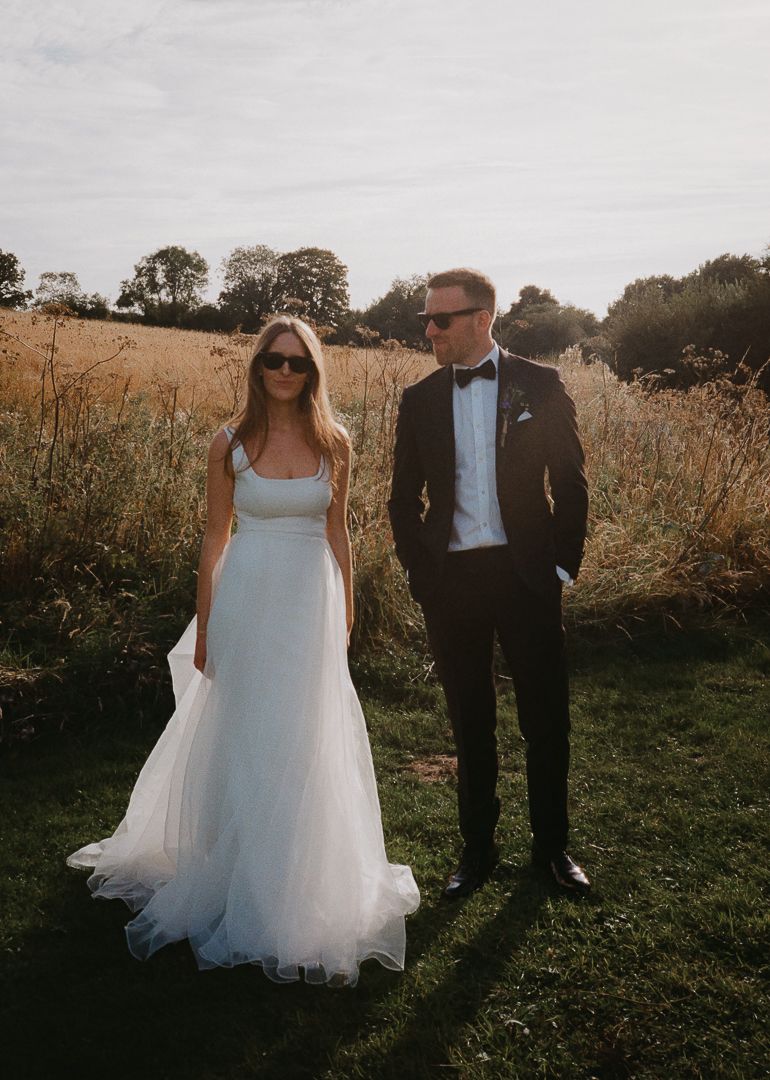 Couple posing in a scenic field
