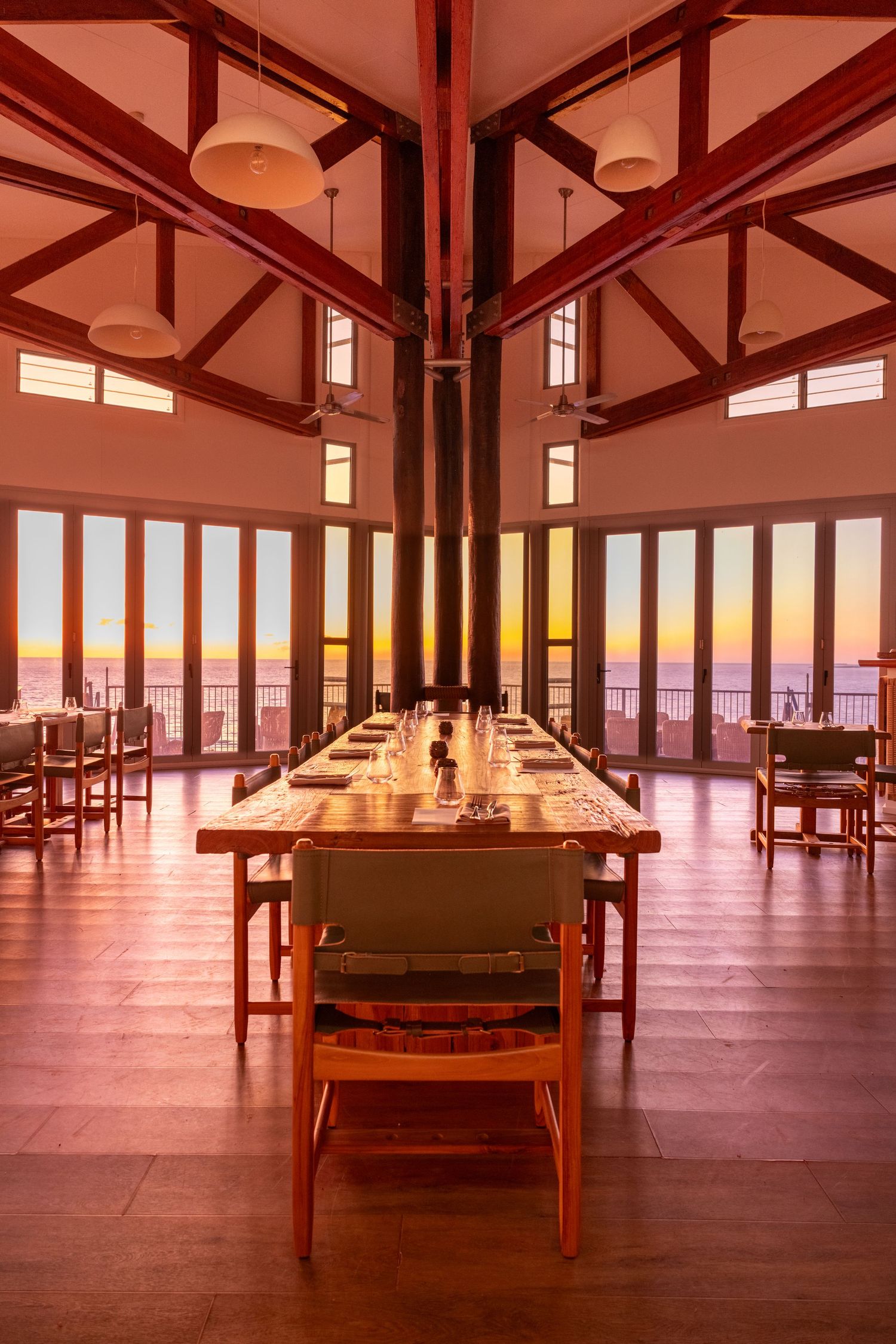 Long dining table at sunrise inside Dunes Restaurant, Berkeley River Lodge