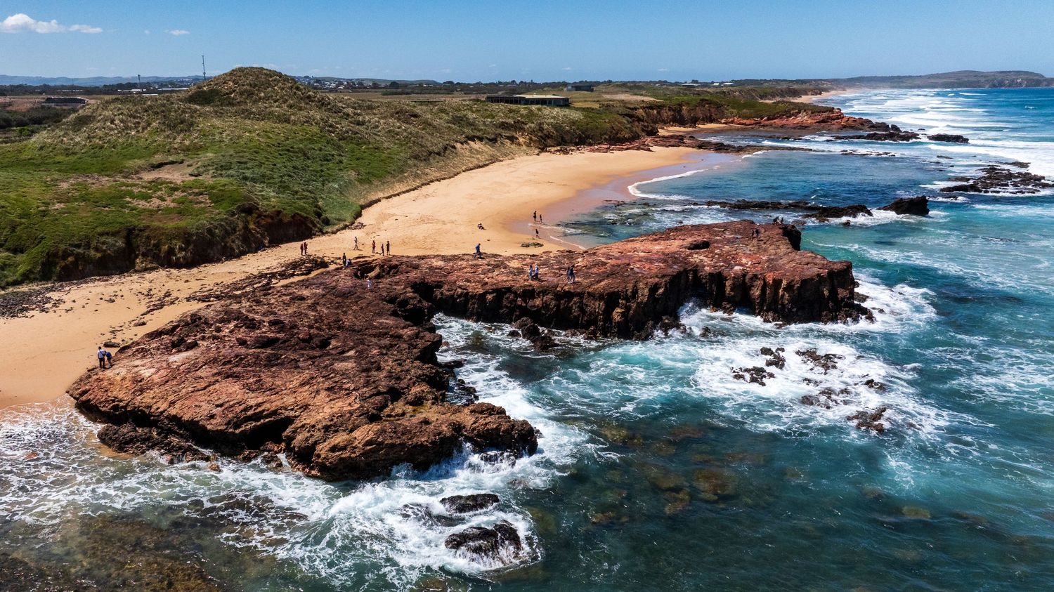 Aerial view of red rocks and surf at Forest Caves beach, Phillip Island