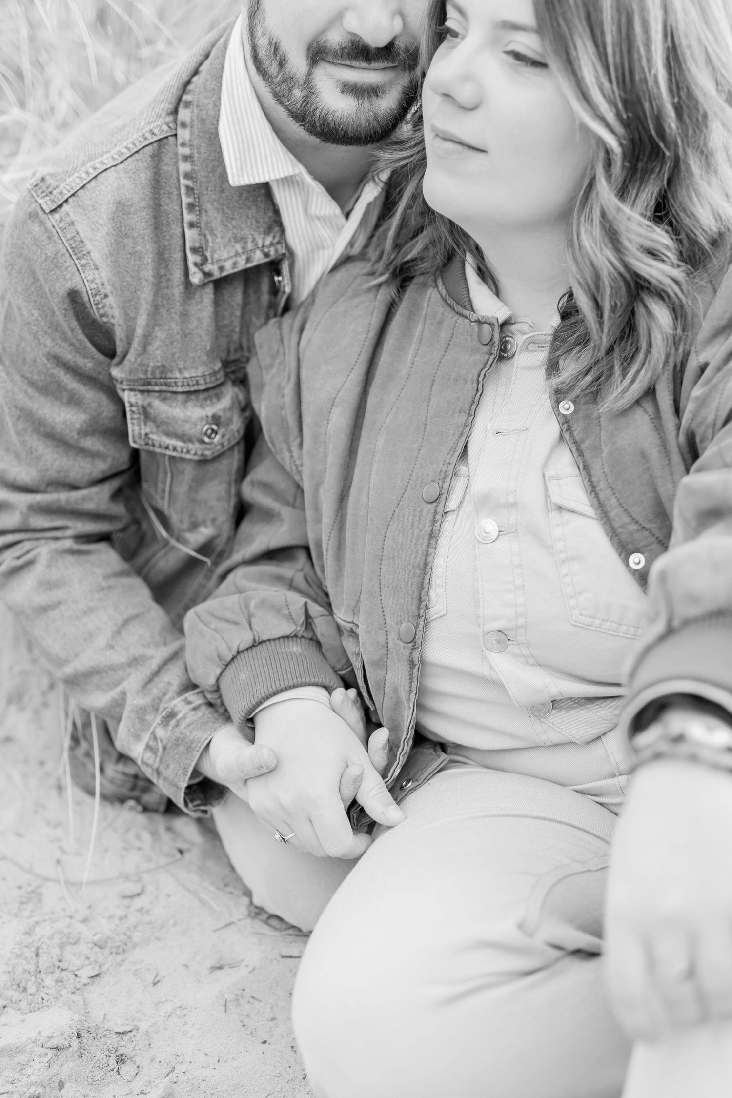 Romantic black and white photo series of a couple relaxing together on a beach.