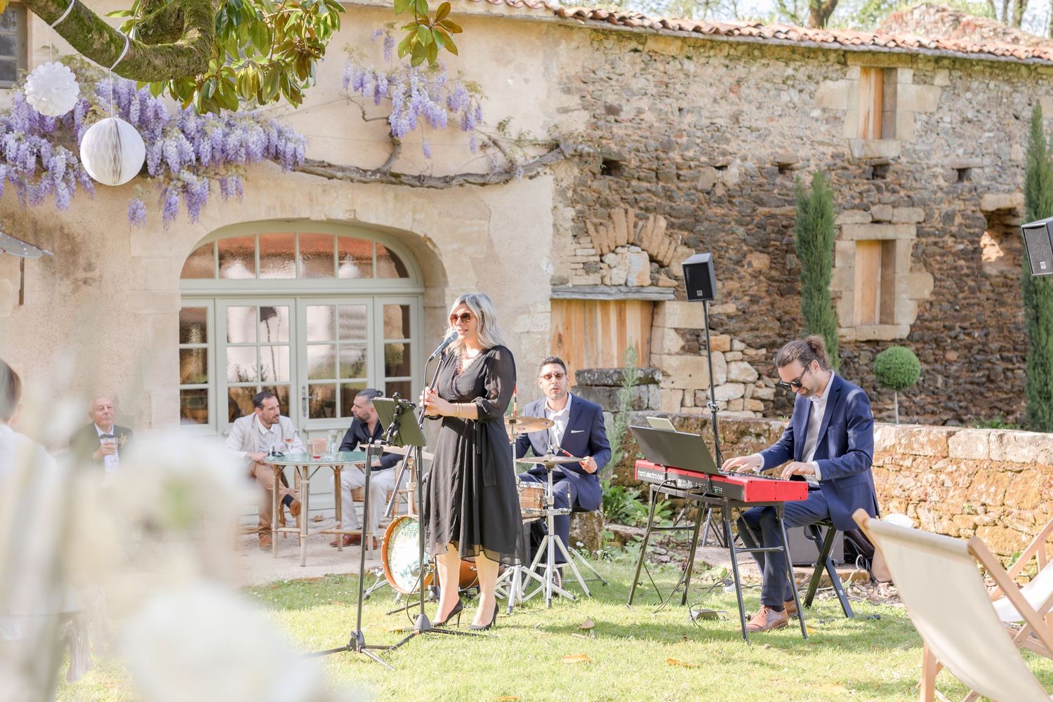 Musical performance setup in a rustic outdoor garden setting.