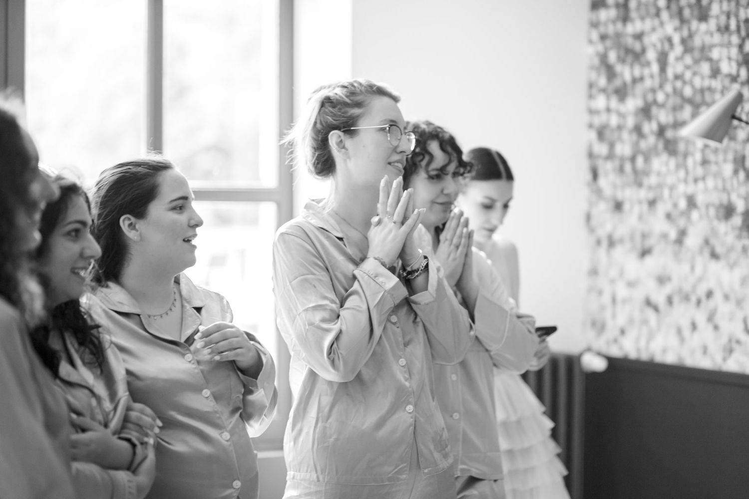 Black and white sequence of emotional reactions during a wedding preparation moment.