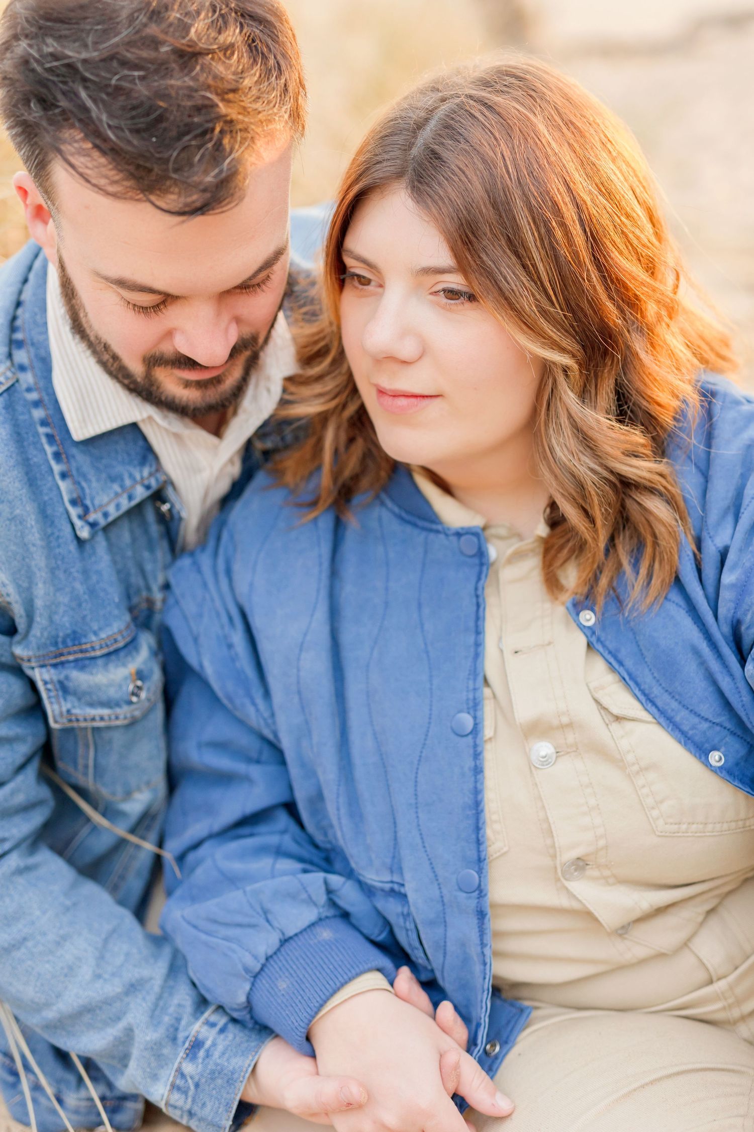 Series of romantic beach portraits showing couple in denim embracing.