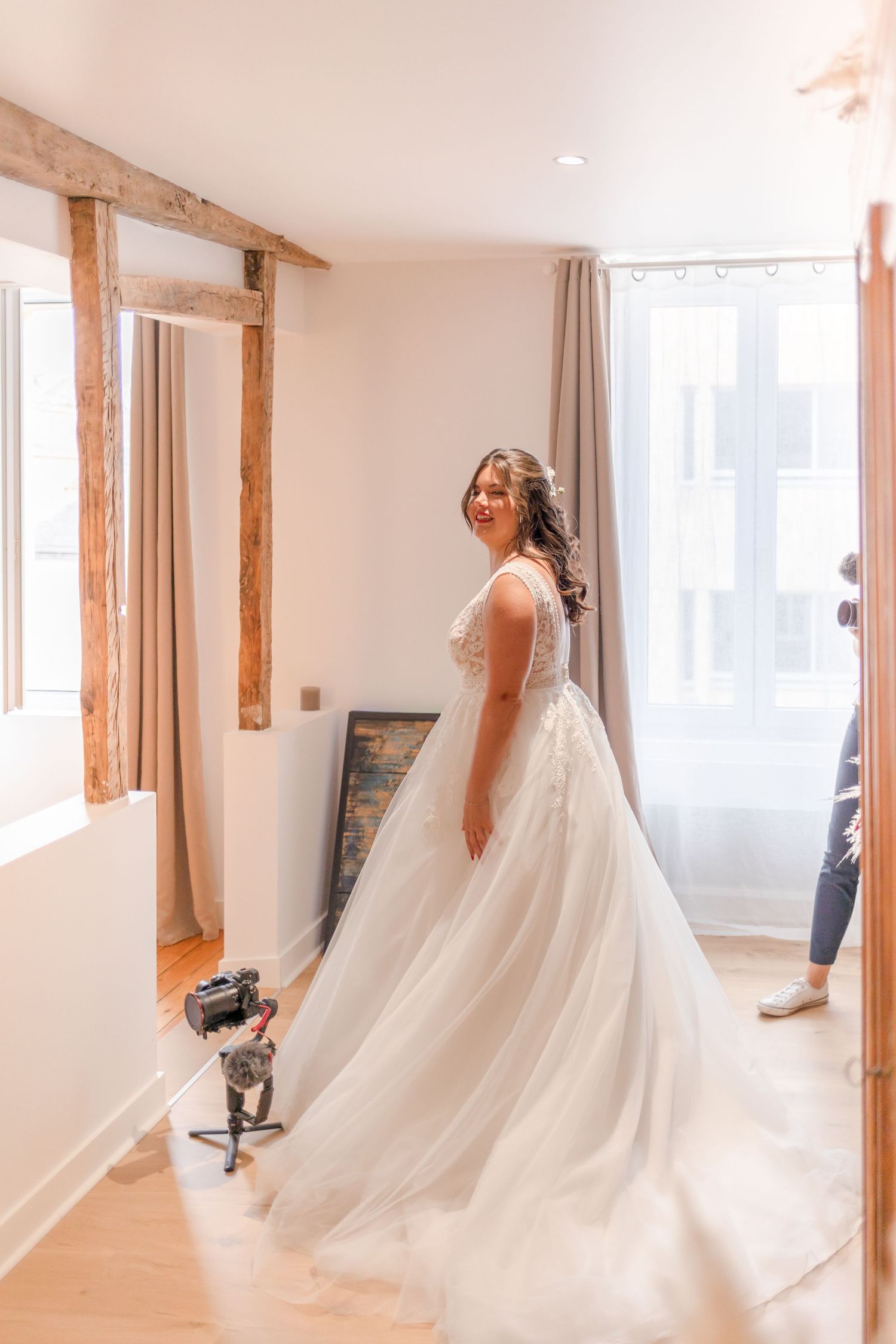 Bride spinning in her wedding gown with flowing tulle skirt in natural light.