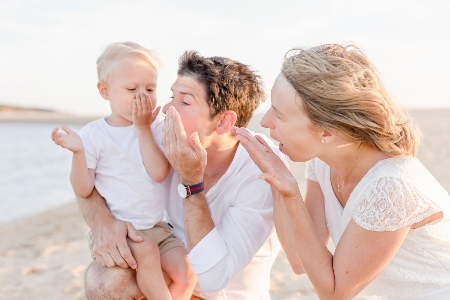 Tender family embraces during sunset beach photography session.