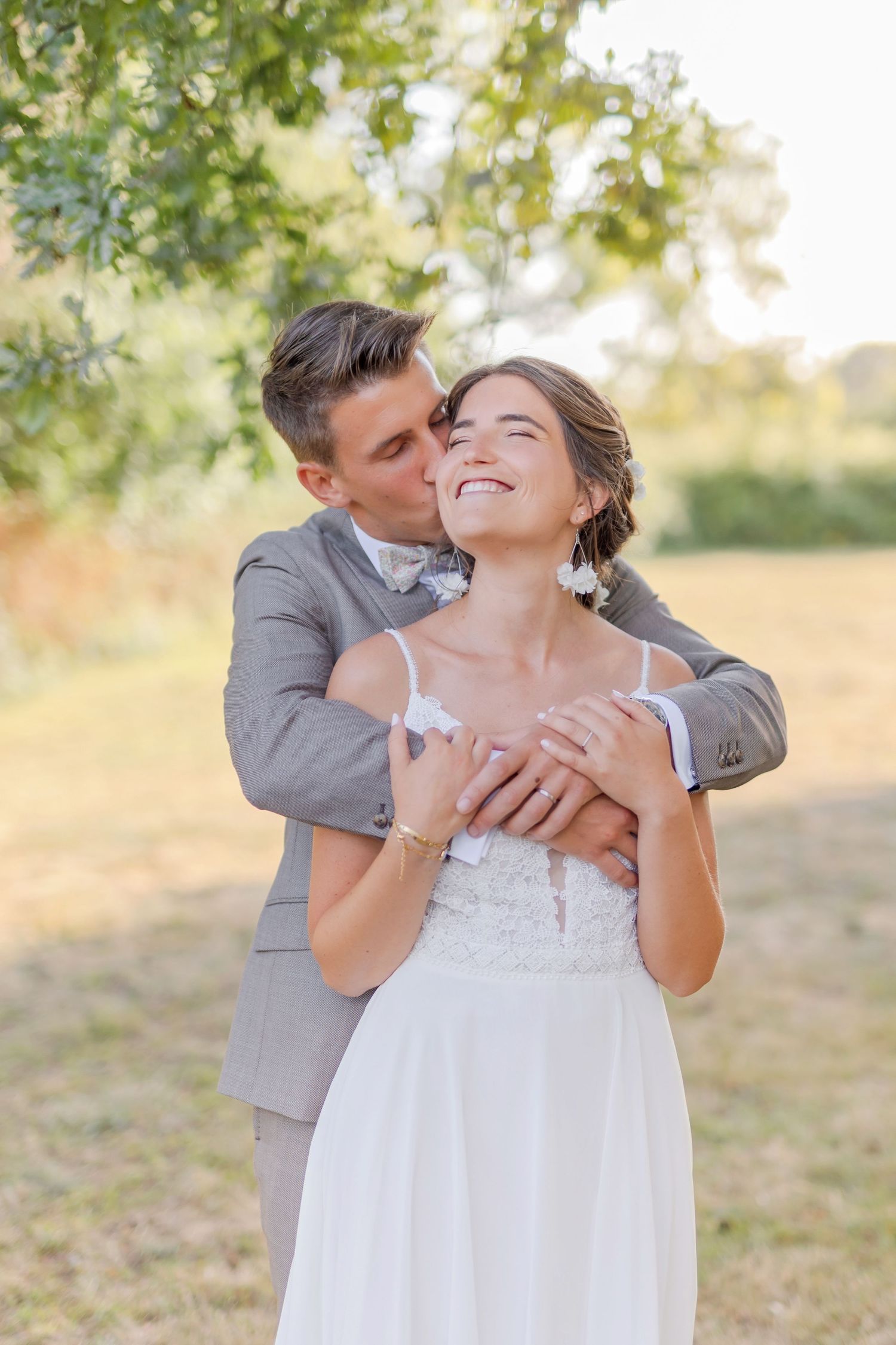 Romantic wedding moment captured in golden outdoor lighting.