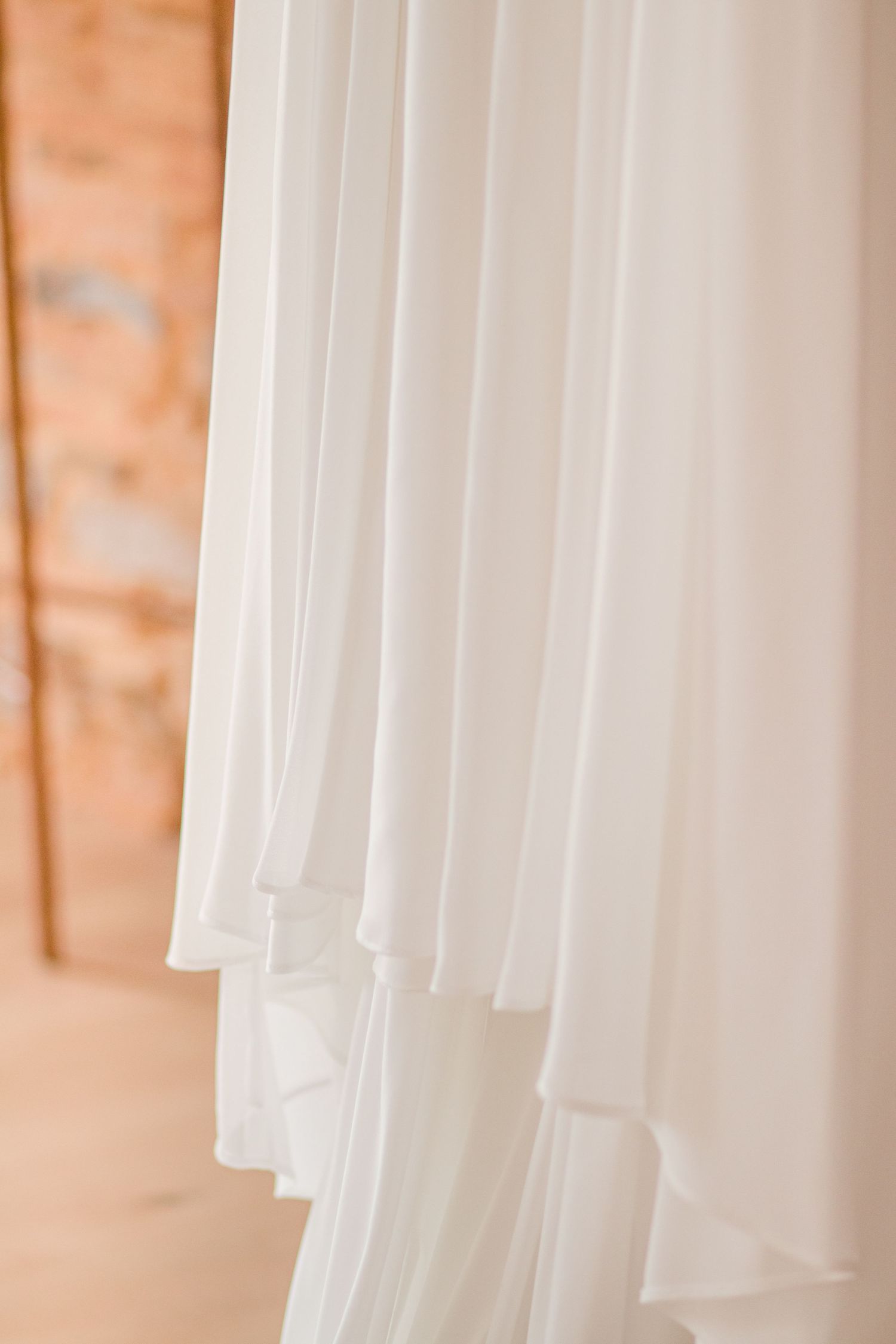 Close-up of flowing white fabric layers with elegant draping detail.