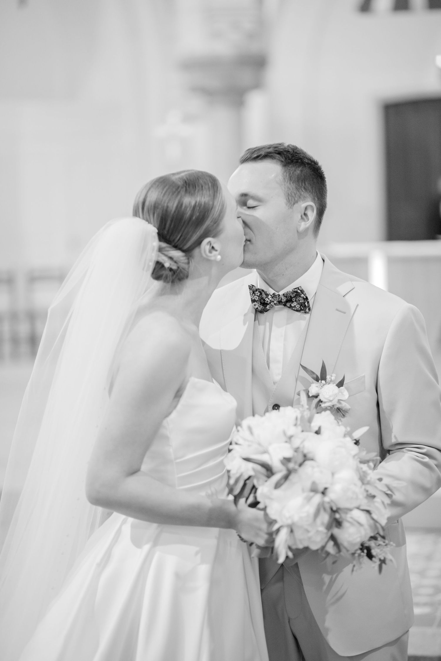 Intimate black and white wedding portrait captured in soft lighting.