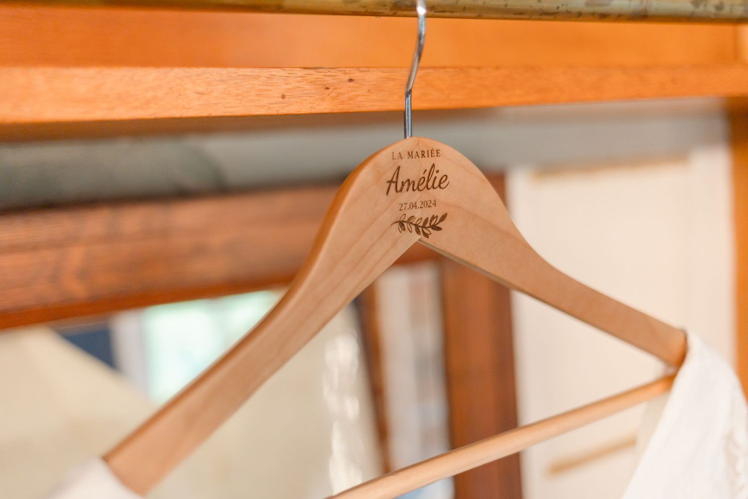 Wooden hangers on a rack at a bridal preparation venue.