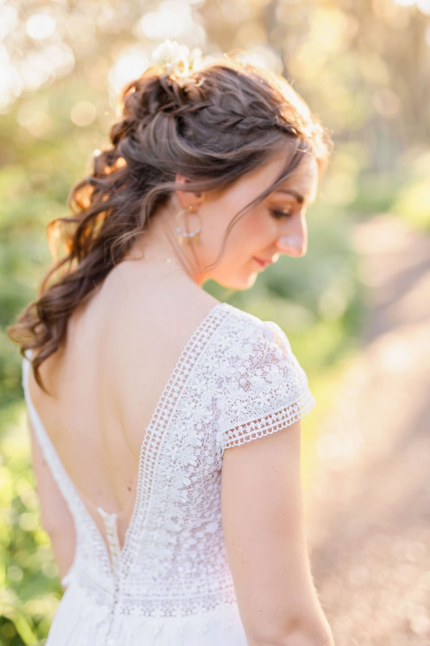 Close-up details of a lace wedding dress with delicate cap sleeves.