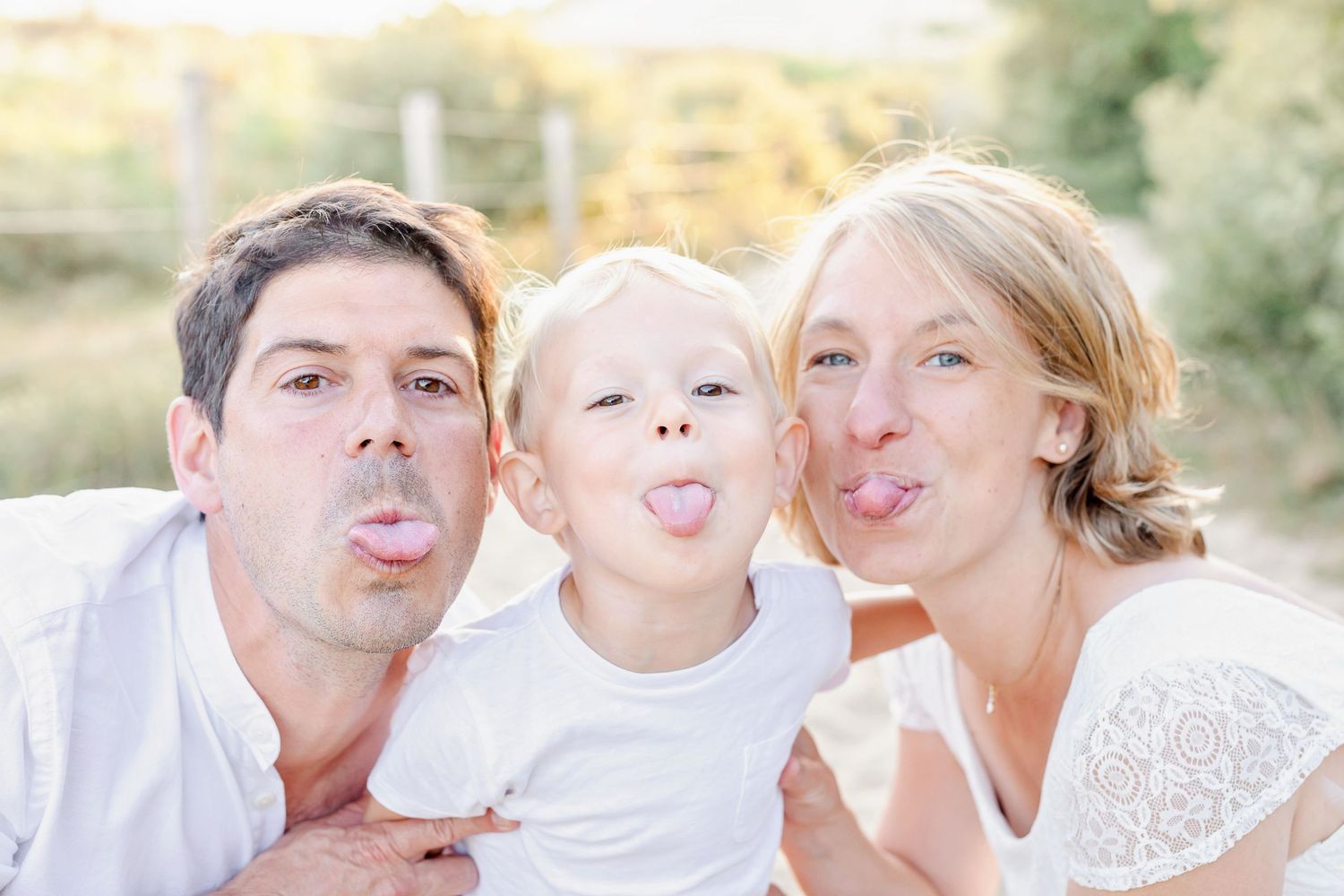 Playful expressions captured in a series of outdoor family portraits during sunset.