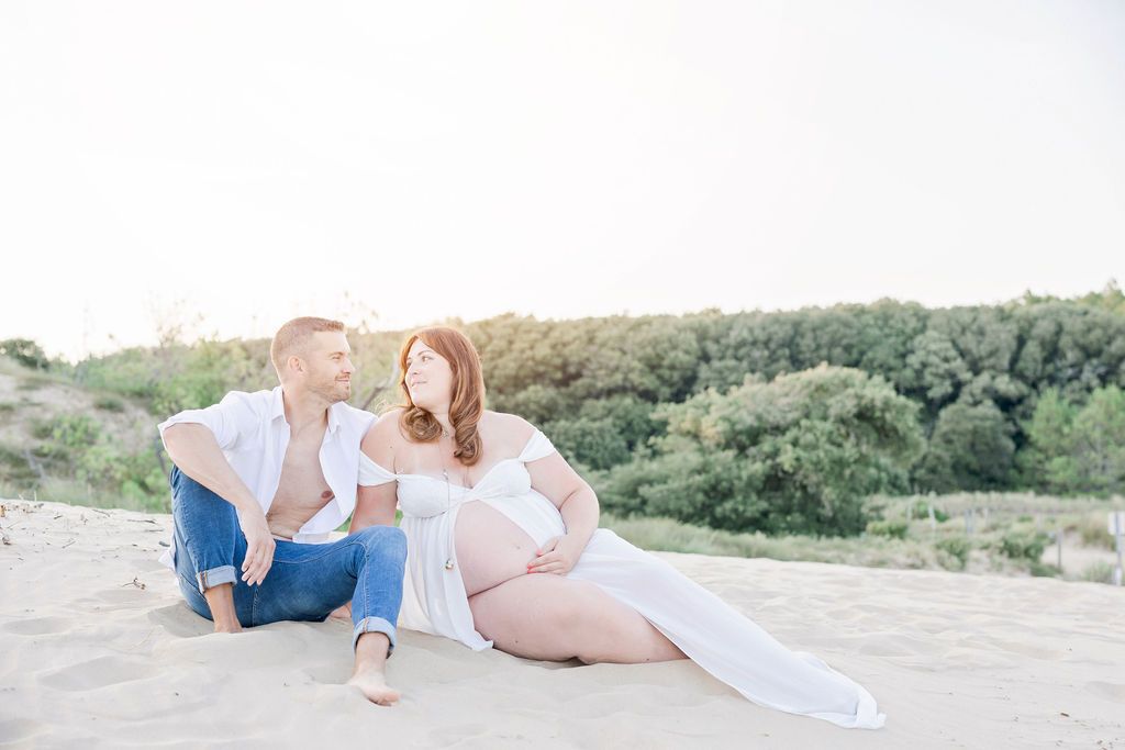 Sweet family beach portrait with playful toddler during sunset photo session.